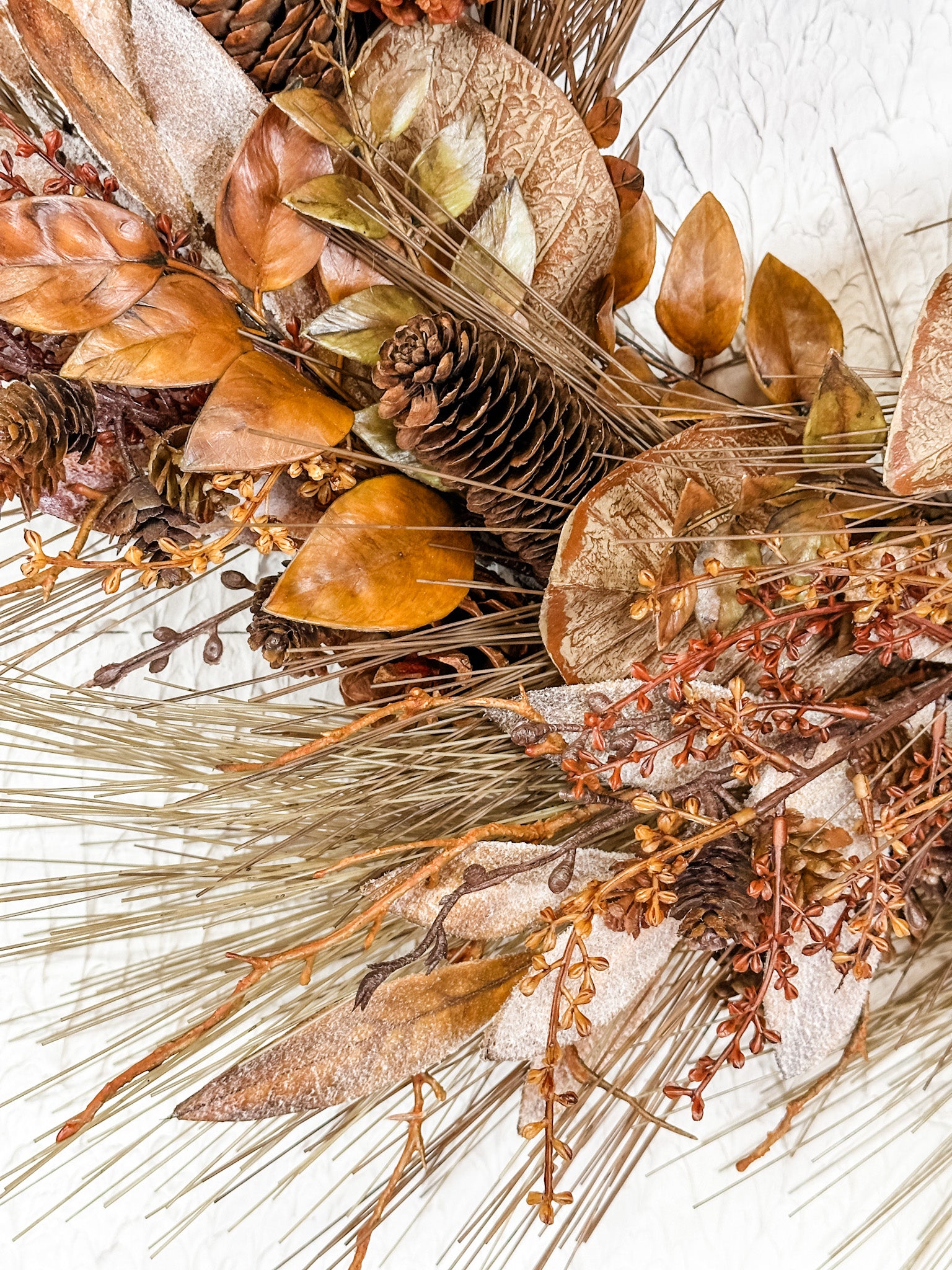 autumn pine cone and bay leaf wreath at the rustic barn in killingworth ct