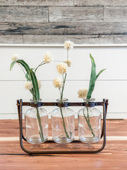 3 glass bottle vases on hinged metal stand at The Rustic Barn in Killingworth, CT