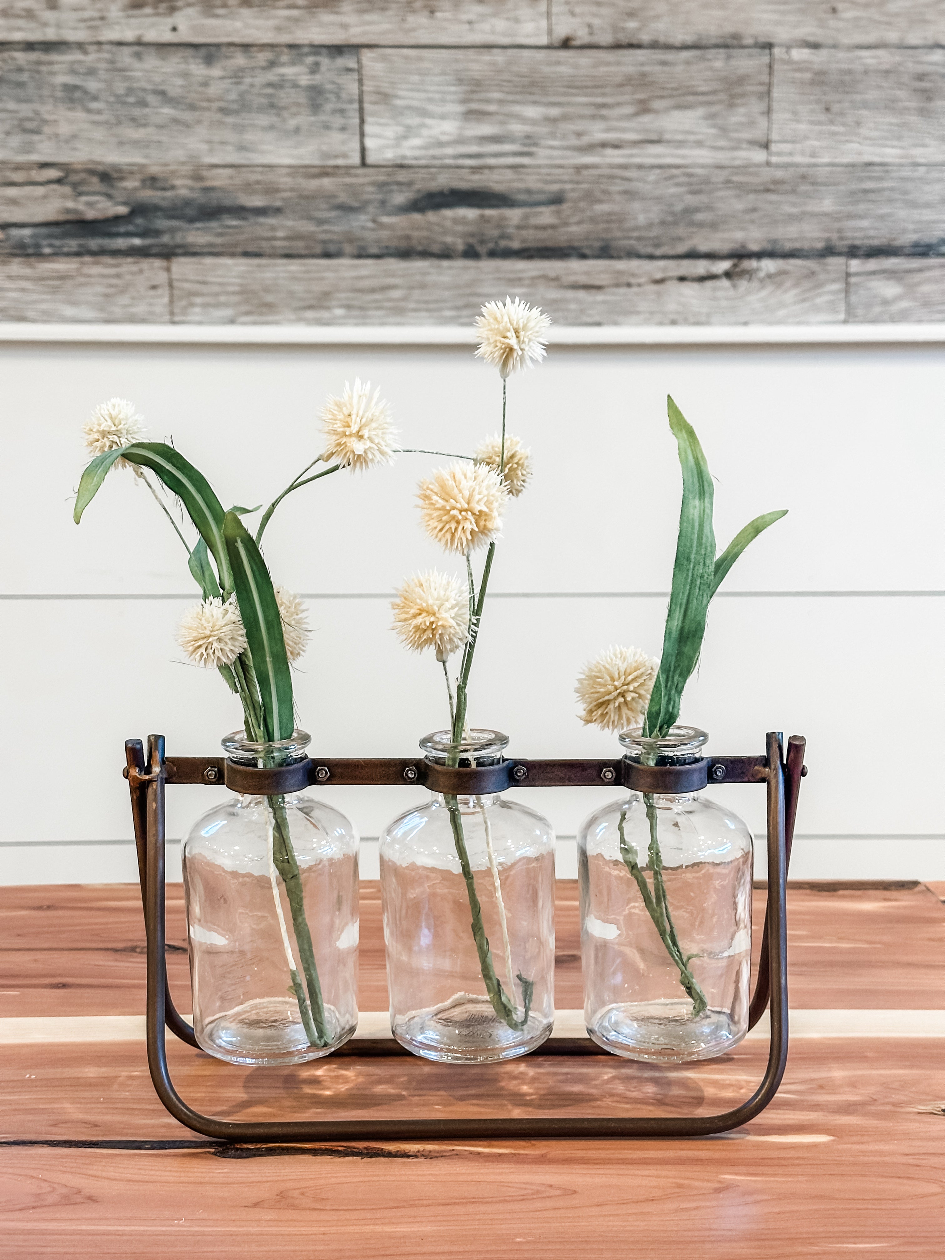 3 glass bottle vases on hinged metal stand at The Rustic Barn in Killingworth, CT
