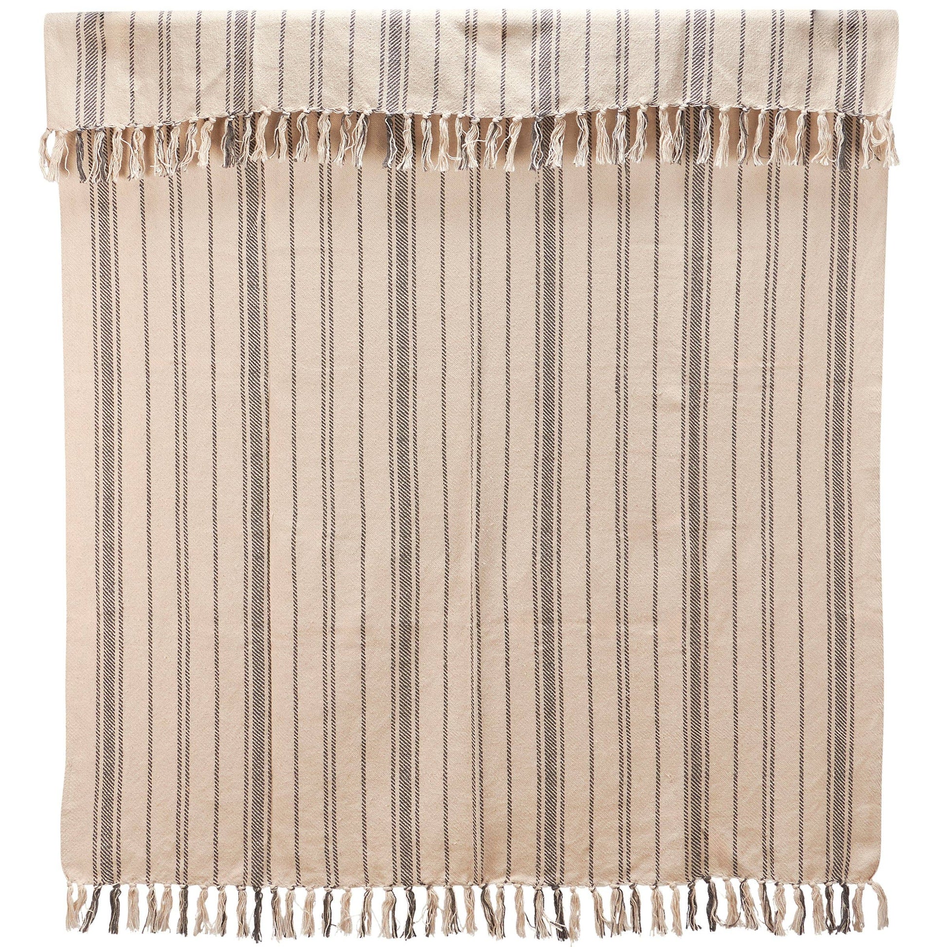 A beige and gray striped cotton throw blanket with tassels on the edges, folded and placed on a flat surface at the rustic barn in killingworth ct
