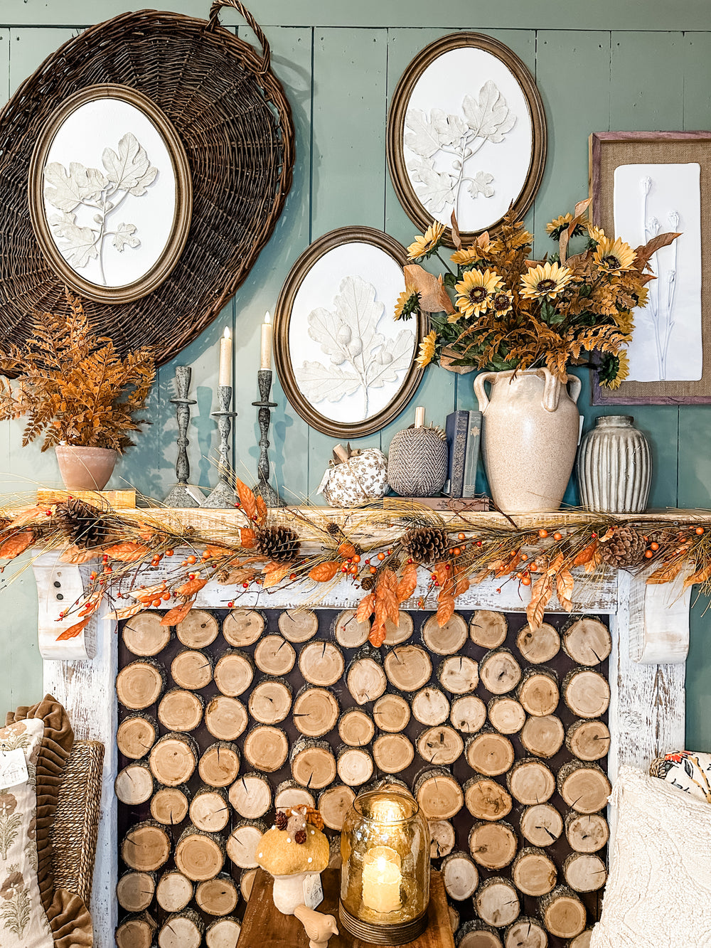 Fall mantel display with vases, weaved baskets, fall photographs, florals, books, and candles at the Rustic Barn in Killingworth, CT