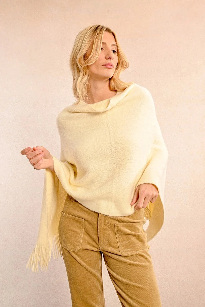 Cream colored cozy fall or winter poncho with fringe detail for sale at the rustic barn in killingworth, CT