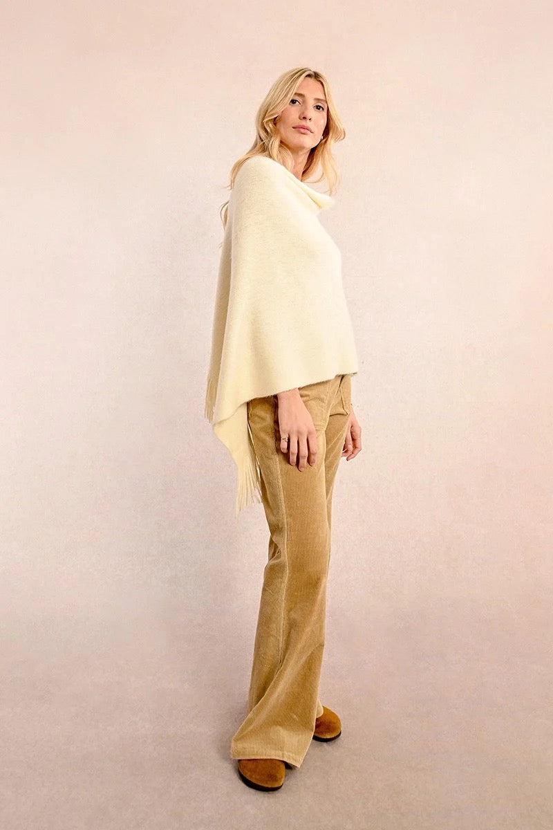 Cream colored cozy fall or winter poncho with fringe detail for sale at the rustic barn in killingworth, CT