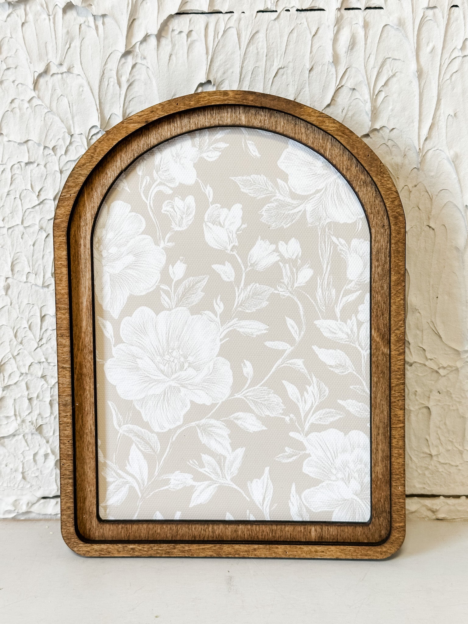 arched framed taupe and white floral wall decor at the rustic barn in killingworth ct
