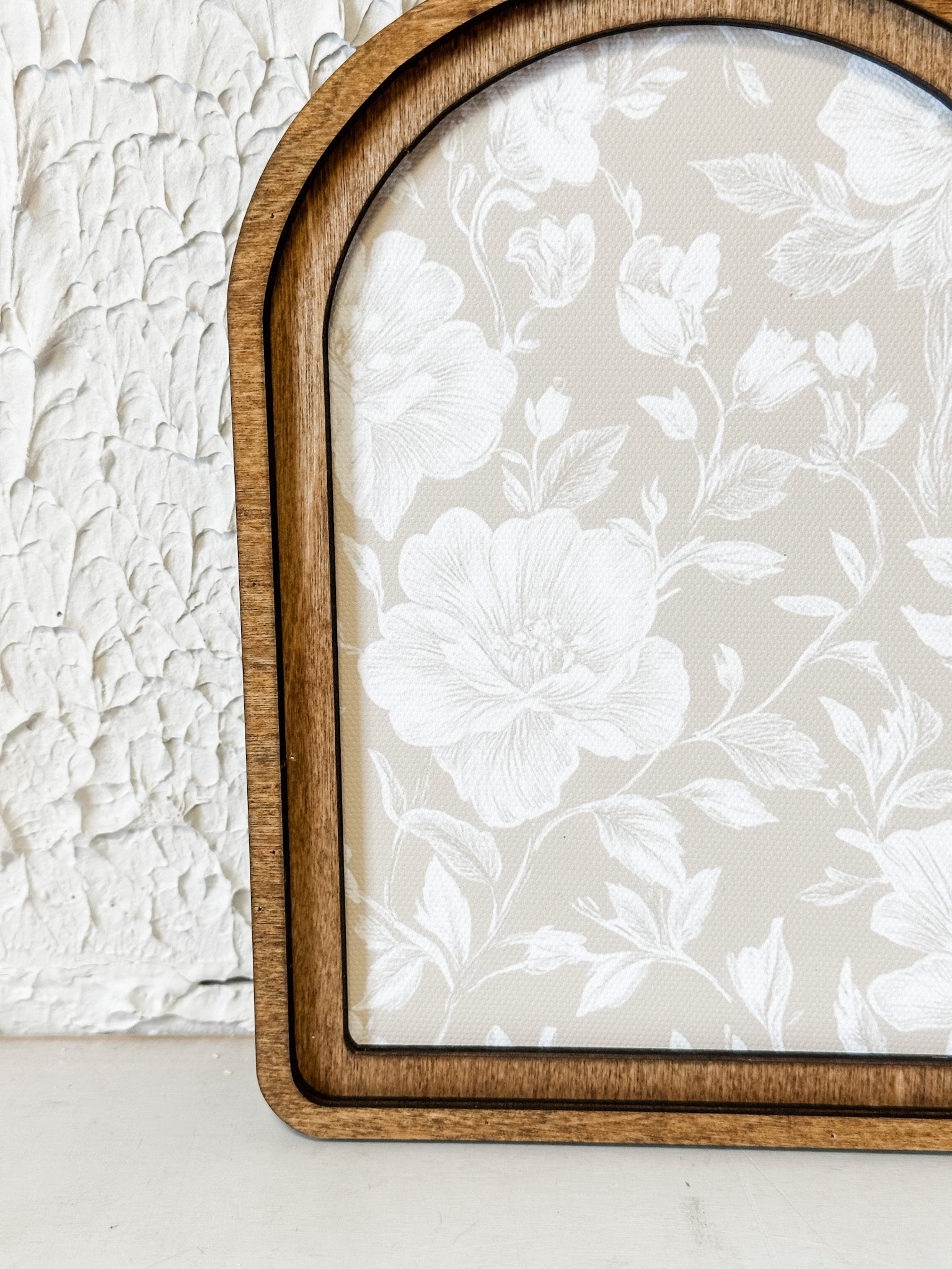 arched framed taupe and white floral wall decor at the rustic barn in killingworth ct
