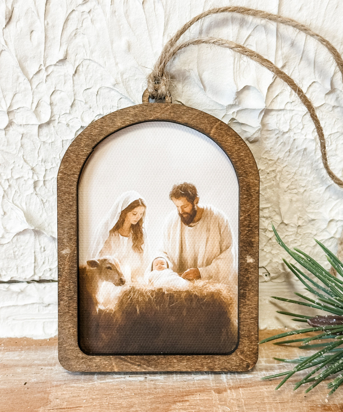 arched wooden ornament with a nativity scene on it at the rustic barn in killingworth ct