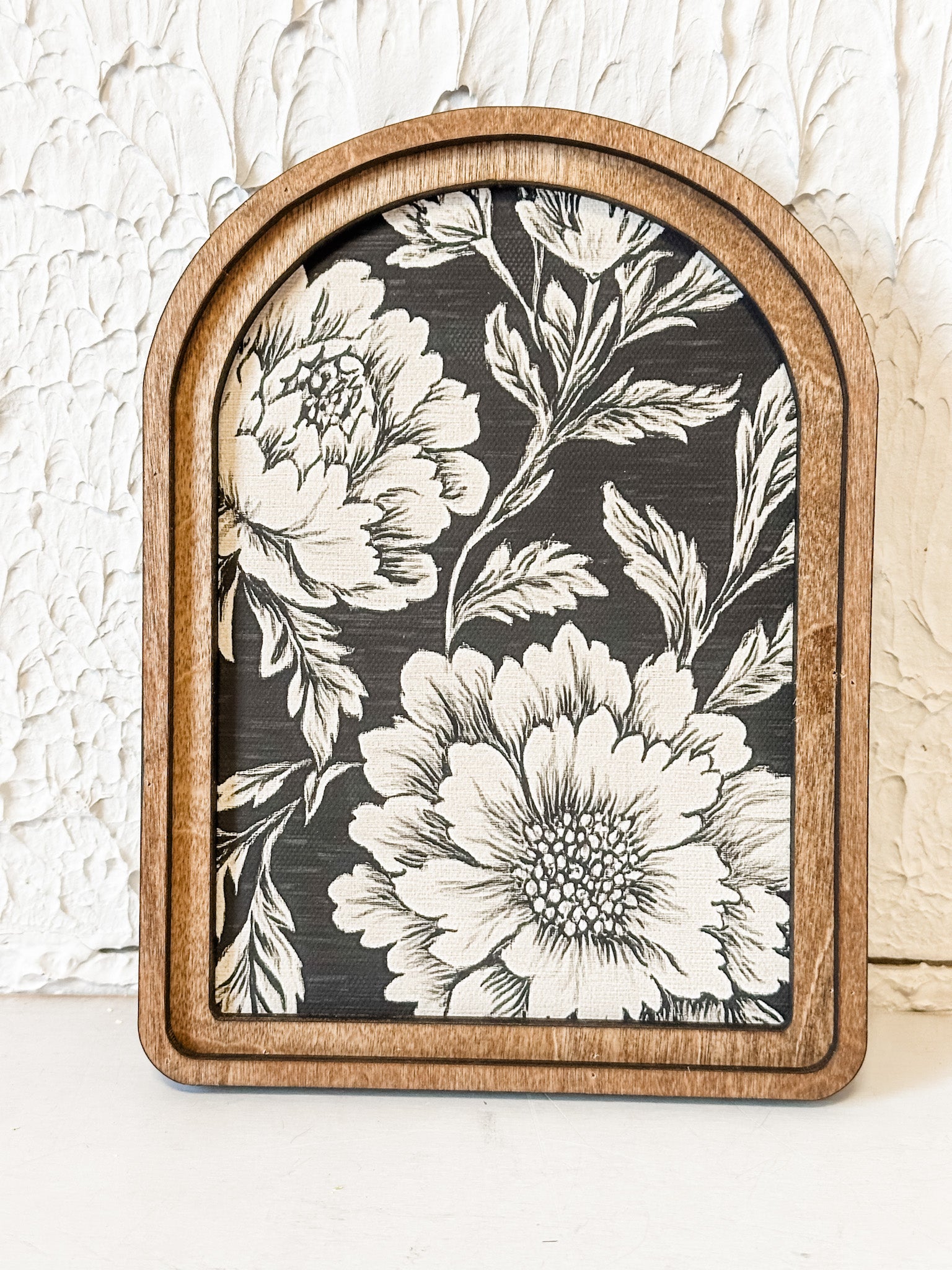 arched framed black and tan floral wall decor at the rustic barn in killingworth ct