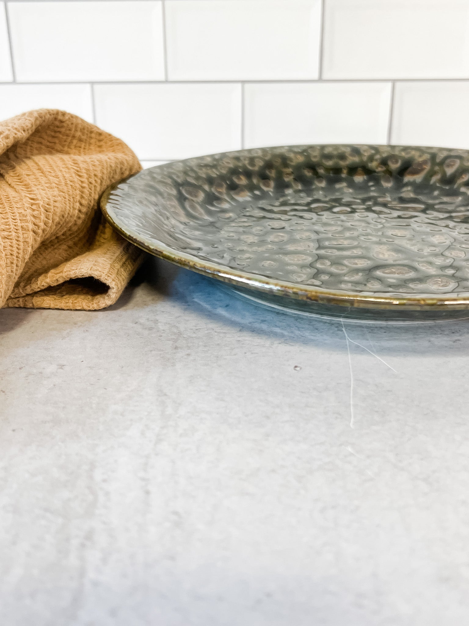 moss green stoneware reactive glaze plate at the rustic barn in killingworth ct