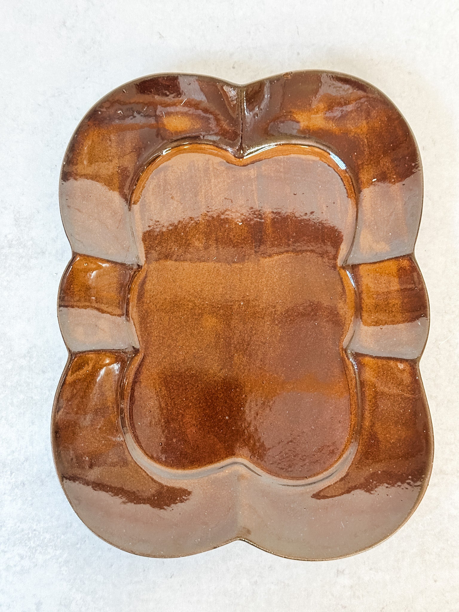 artisanal scalloped brown reactive glaze stoneware plate at the rustic barn in killingworth ct
