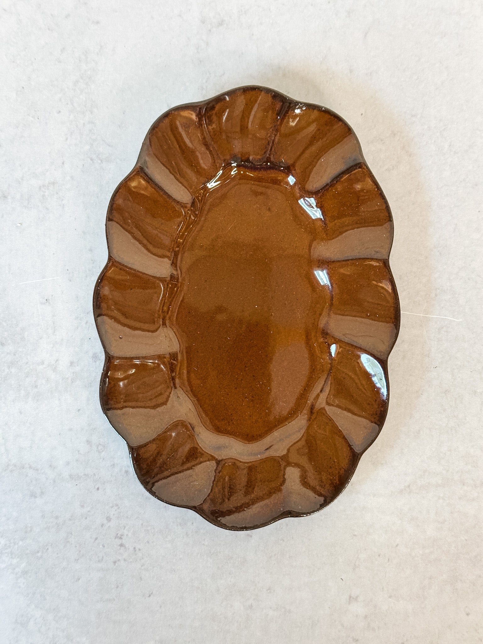 artisanal scalloped brown reactive glaze stoneware plate at the rustic barn in killingworth ct