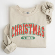 Beige sweatshirt with 'Christmas Vibes' text on a white background