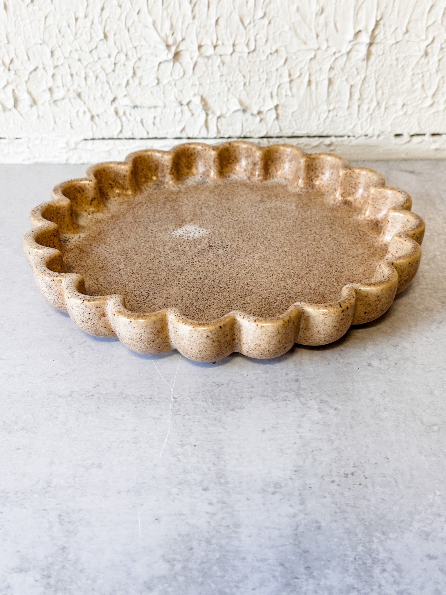 beige speckled ceramic scallop dish at the rustic barn in killingworth ct