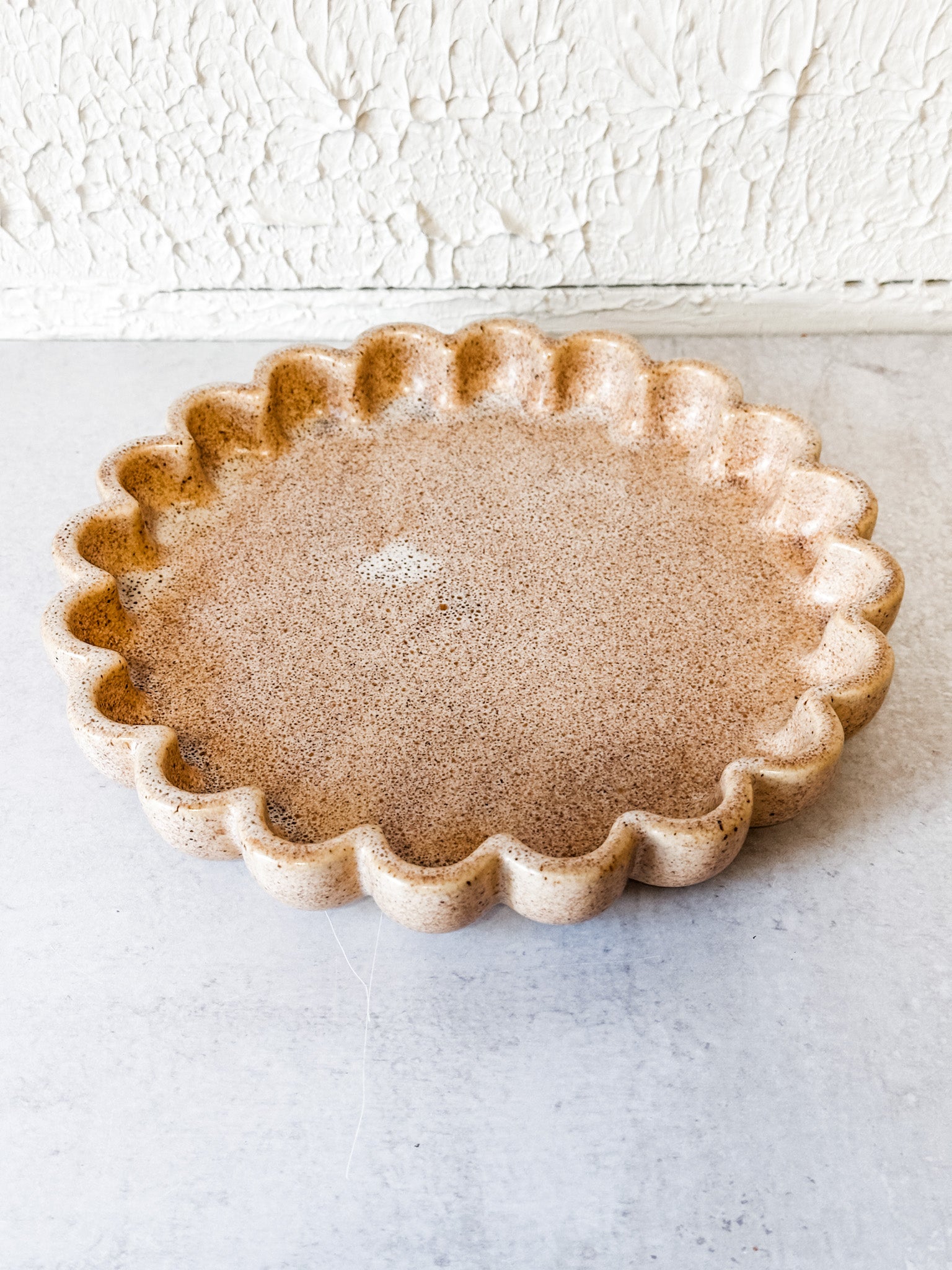 beige speckled ceramic scallop dish at the rustic barn in killingworth ct