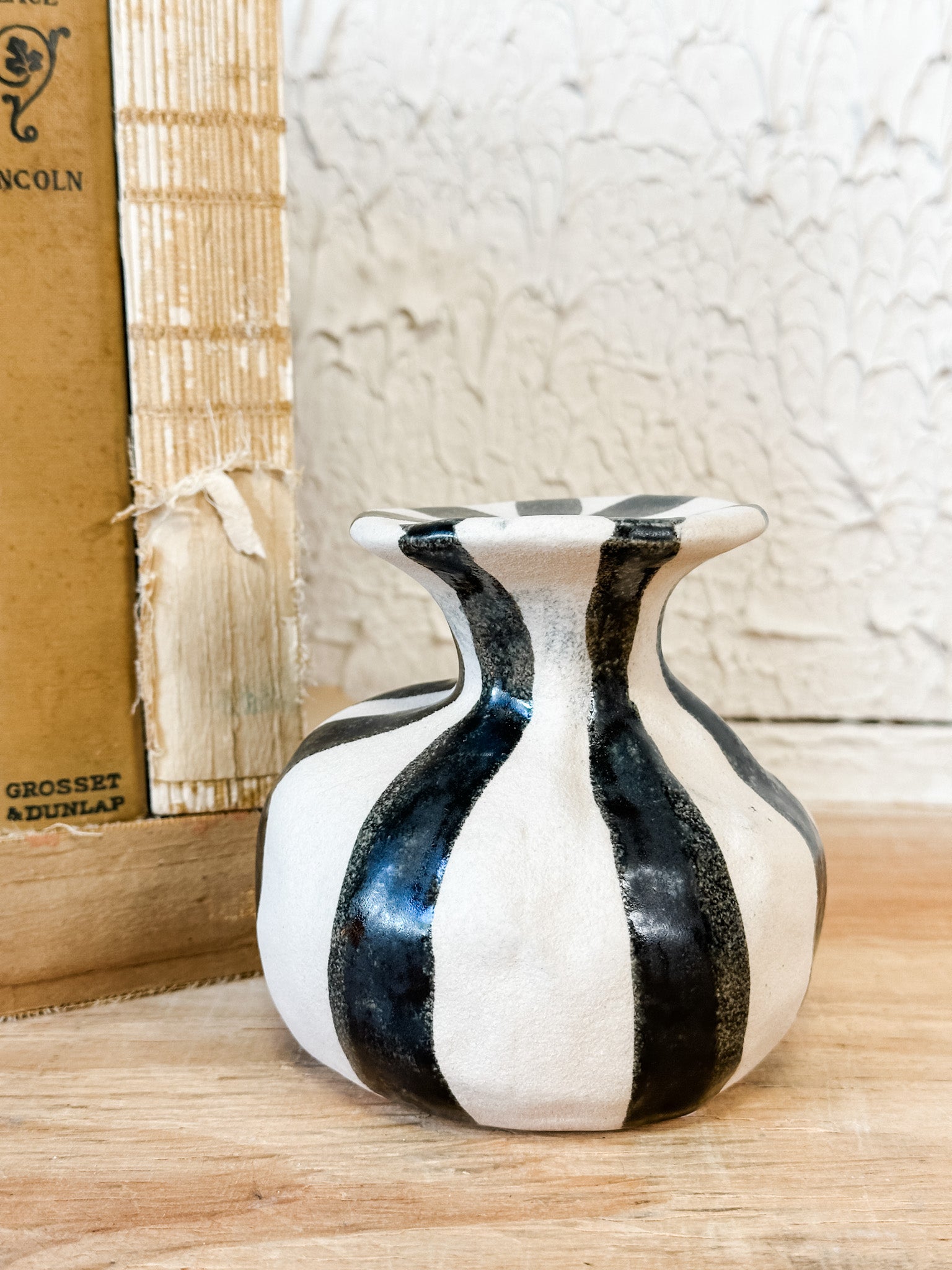 black and white striped ceramic taper holder at the rustic barn in killingworth ct