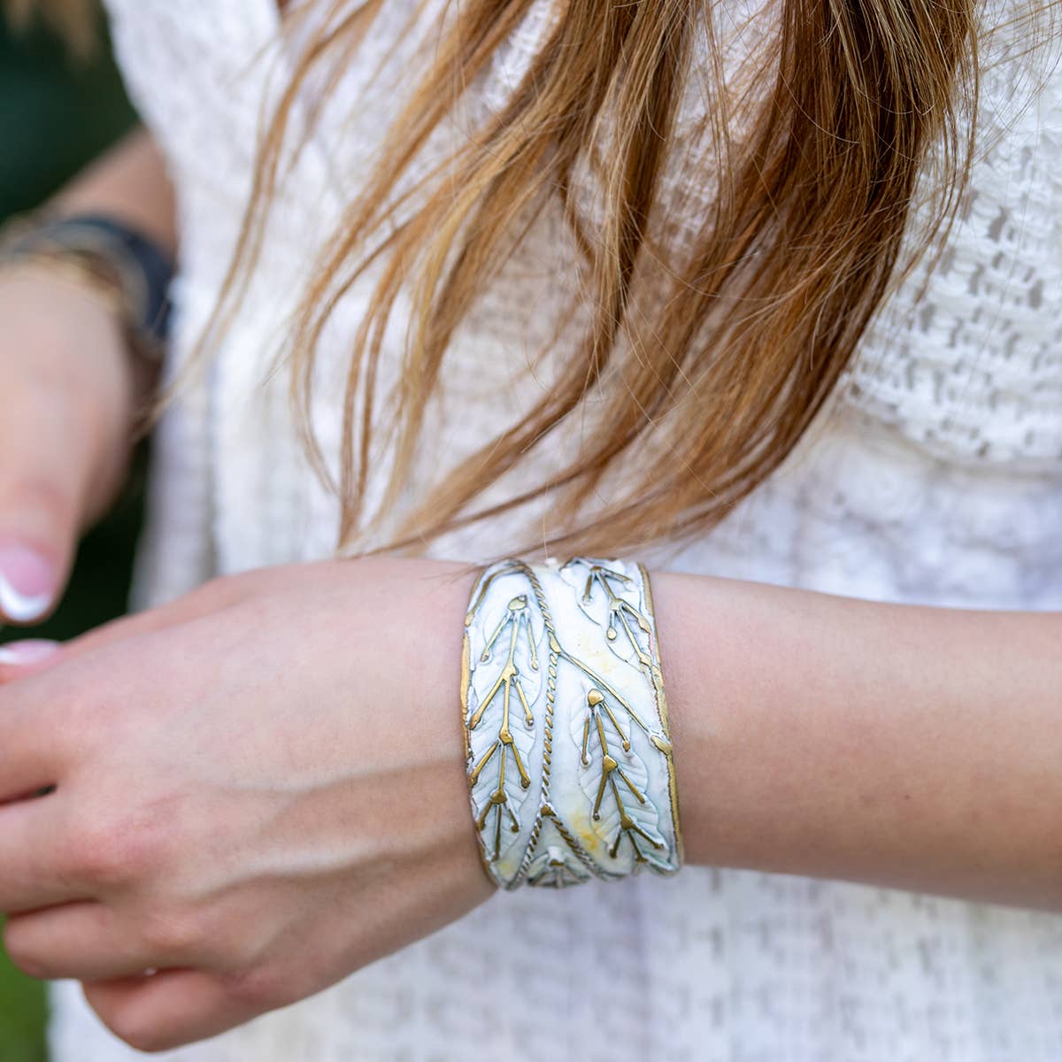 brass patina cuff bracelet with white leaaves at the rustic barn in killingworth ct