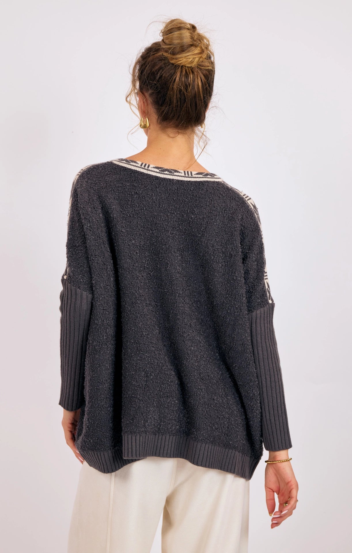 charcoal v-neck sweater with pattern on the neckline and patterned pockets on the side at the rustic barn in Killingworth CT