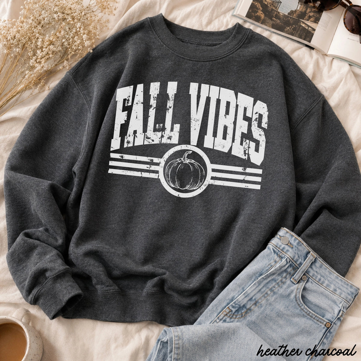 Dark gray sweatshirt with 'Fall Vibes' and pumpkin graphic on a light at the rustic barn in killingworth ct