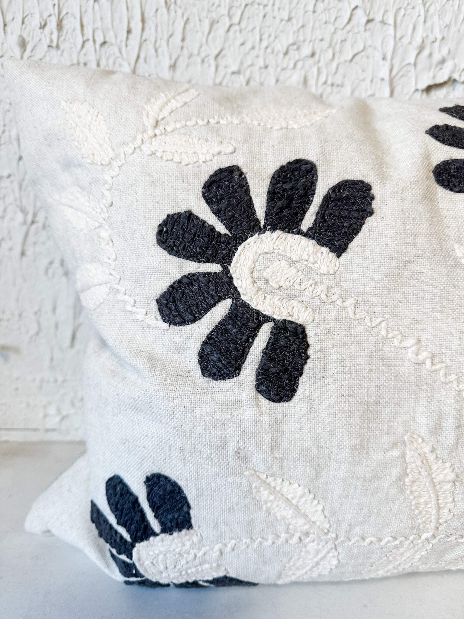 hand embroidered charcoal petal lumbar pillow at the rustic barn in killingworth ct