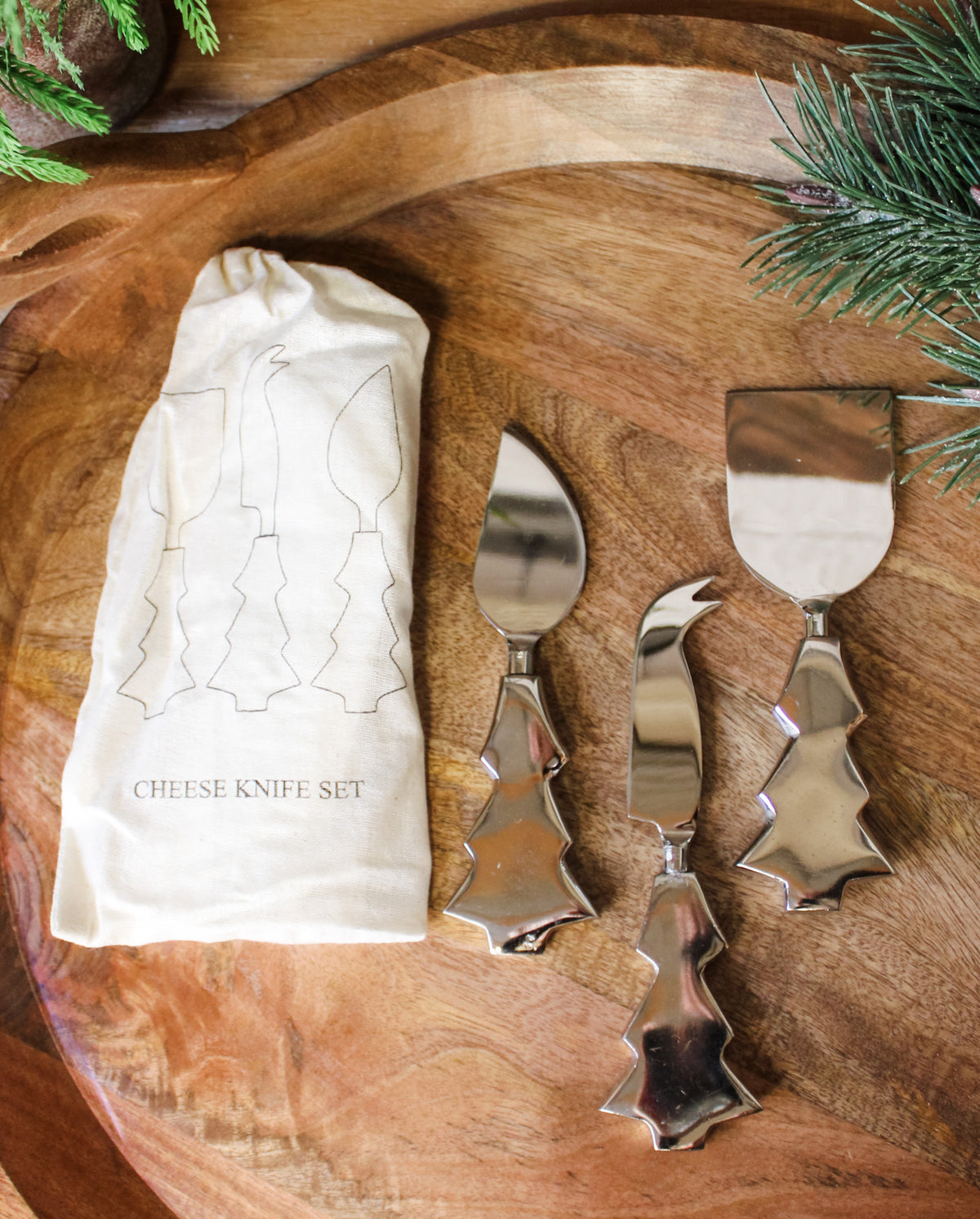Cheese knife set for the holidays and christmas silver knife set with christmas tree base design and bag to hold them for sale at the rustic barn in killingworth, CT