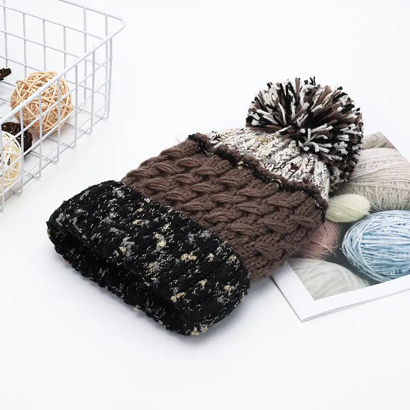 contrat color brown and black pom pom beanie hat at the rustic barn in killingworth ct