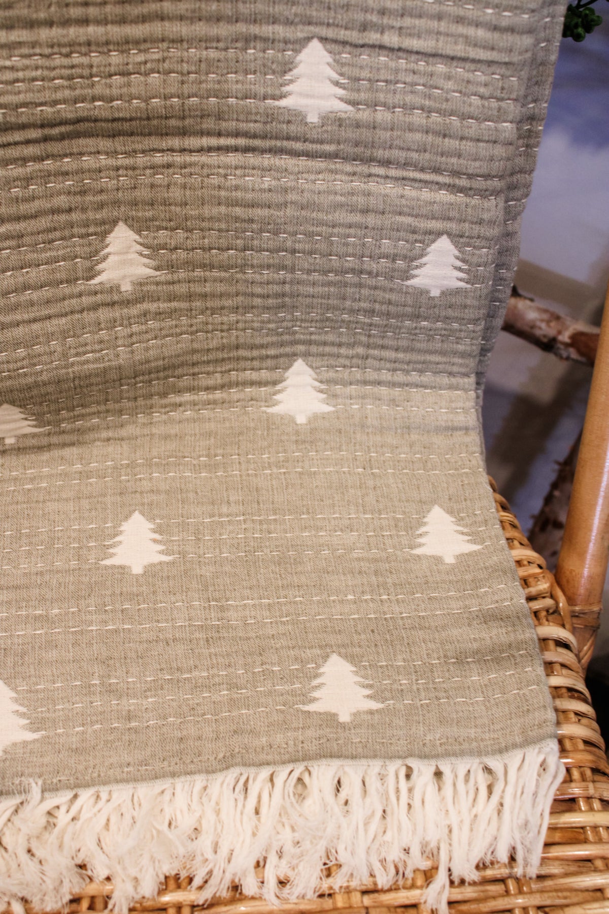 Sage green kantha throw embroidered with christmas pine trees and cream white colored fringe for winter and christmas for sale at the rustic barn in killingworth ,CT