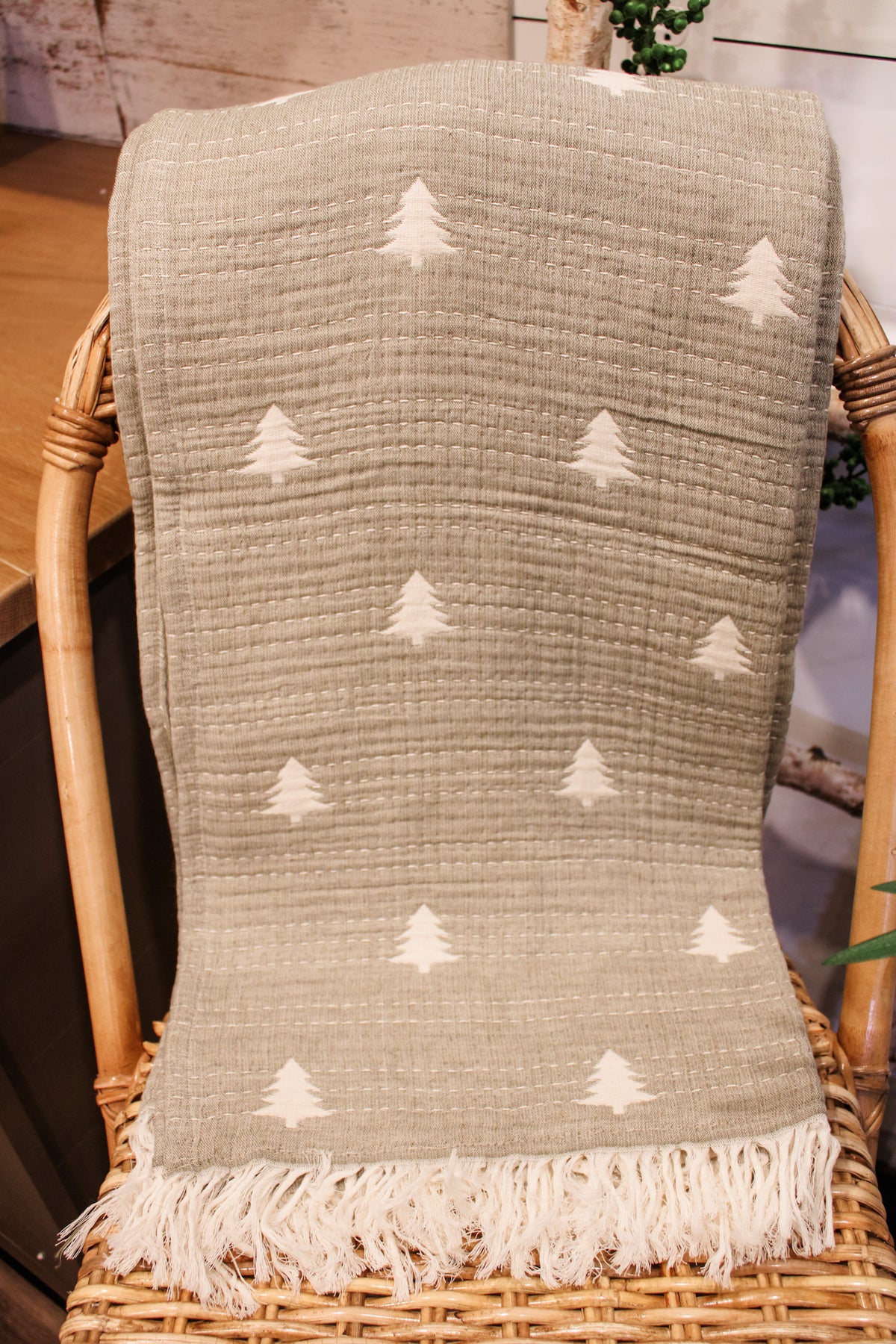 Sage green kantha throw embroidered with christmas pine trees and cream white colored fringe for winter and christmas for sale at the rustic barn in killingworth ,CT