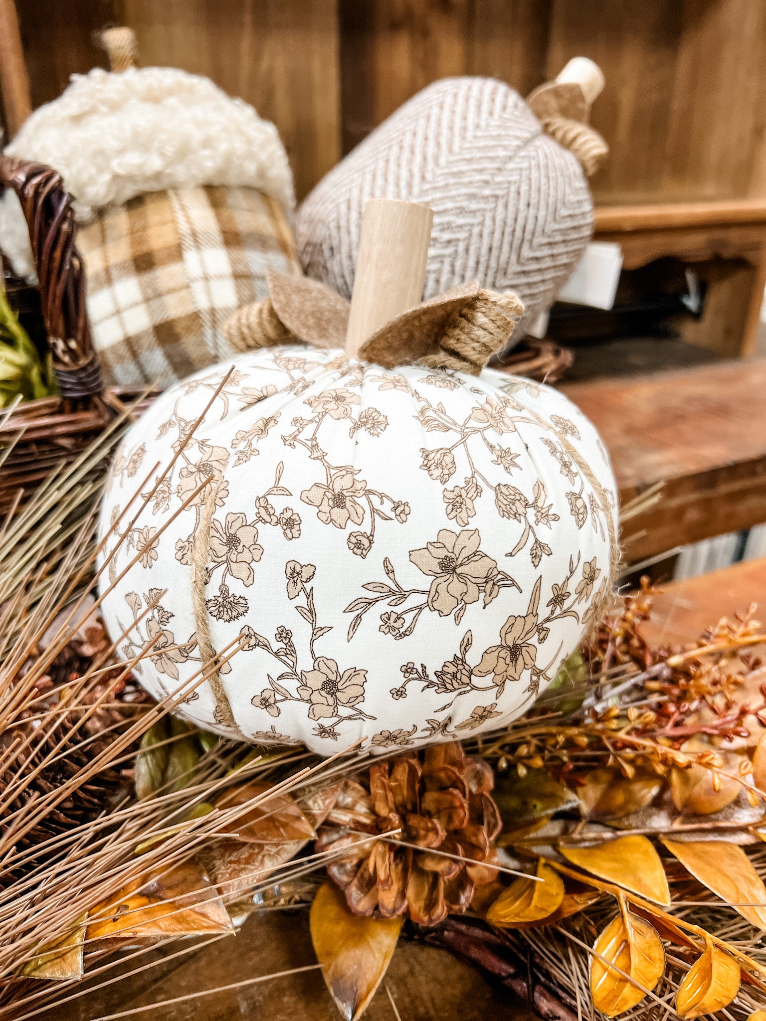 A decorative white pumpkin with a brown floral vine pattern at the rustic barn in killingworth ct