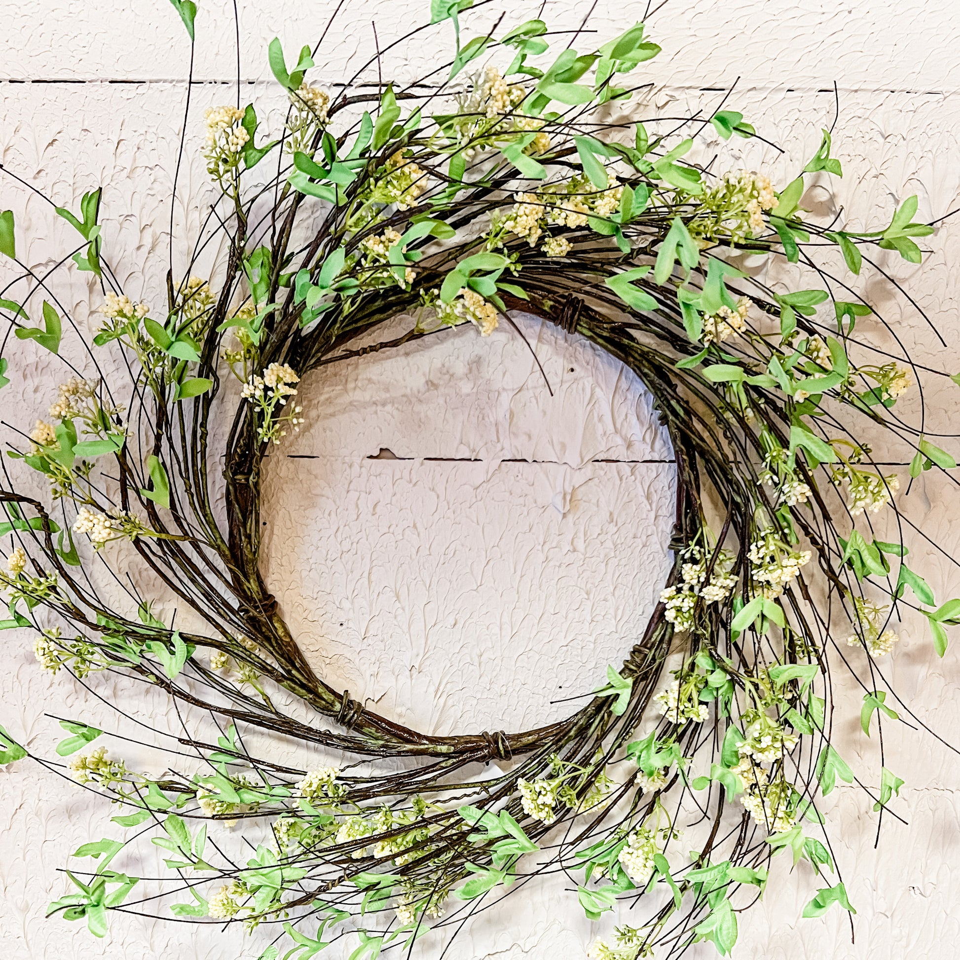 wreath made of vines green leaves and cream berries at the rustic barn in killingworth ct
