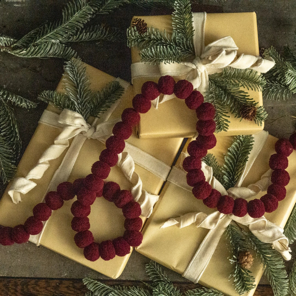 dark red 6 foot pom pom christmas garland at the rustic barn in killingworth ct