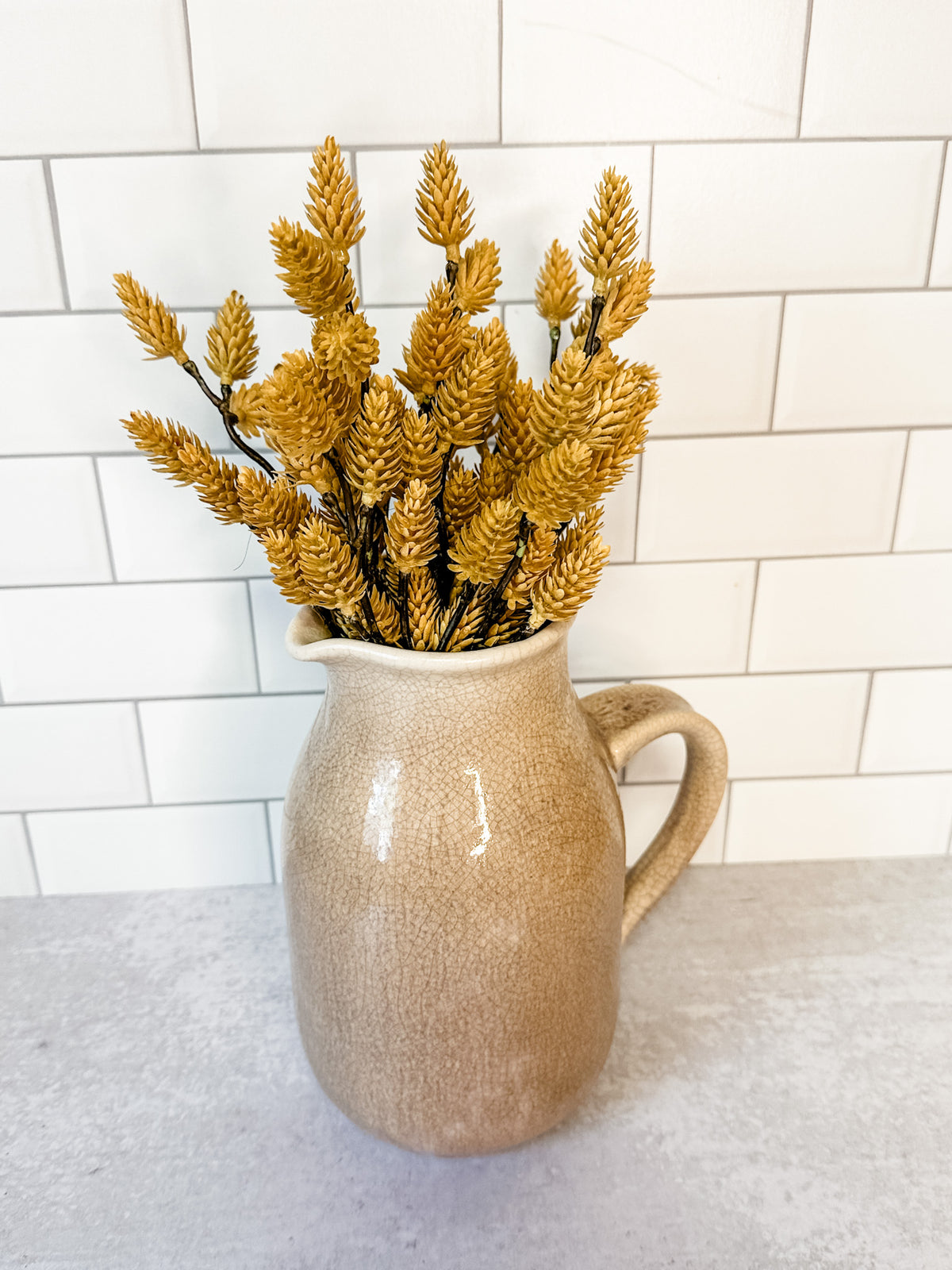 Distressed artisanal cream stoneware pitcher with reactive crackle glaze for sale at the rustic barn in killingworth, CT