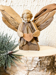 driftwood angel holding heart ornament at the rustic barn in killingworth ct