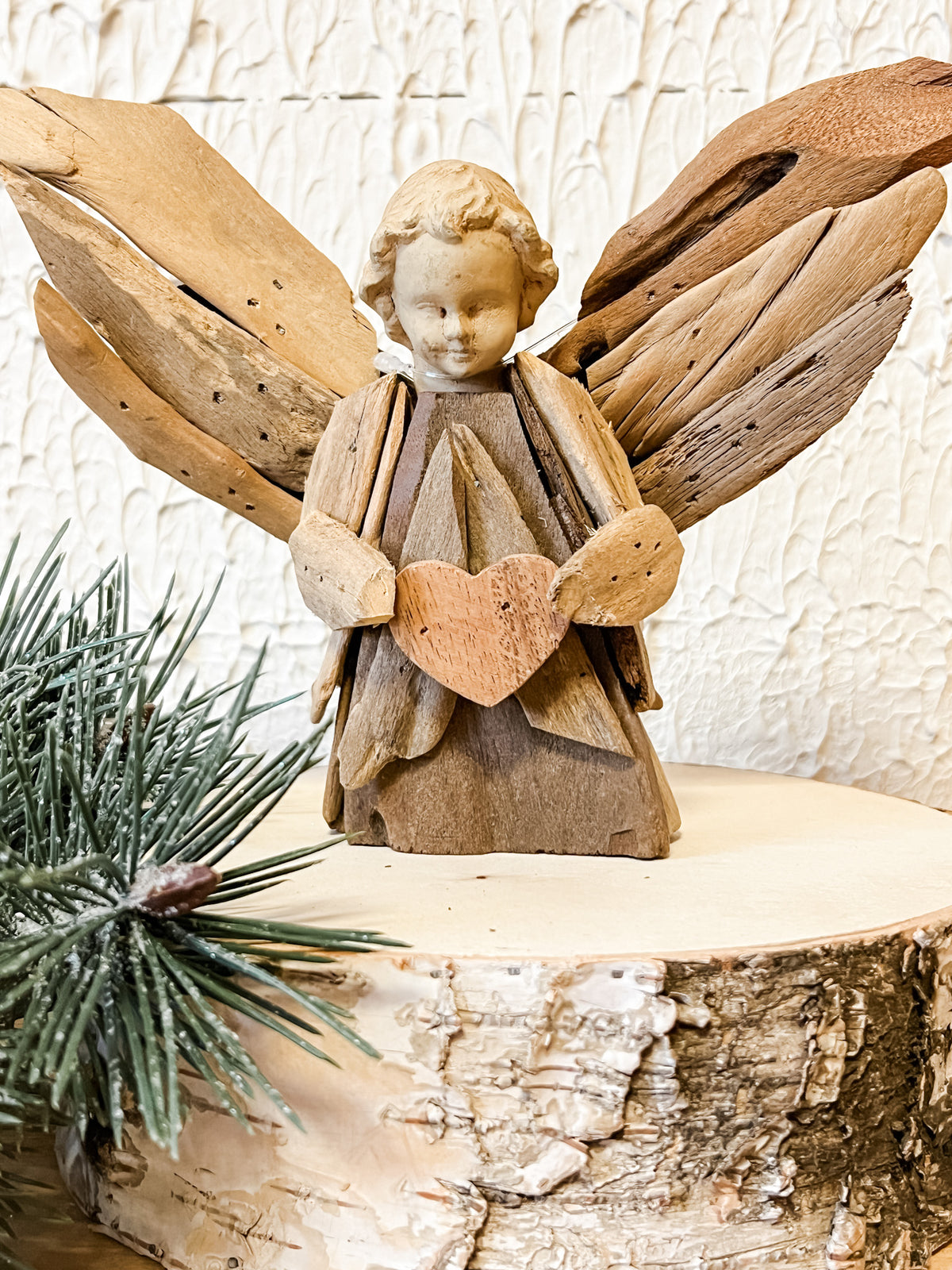 driftwood angel holding heart ornament at the rustic barn in killingworth ct