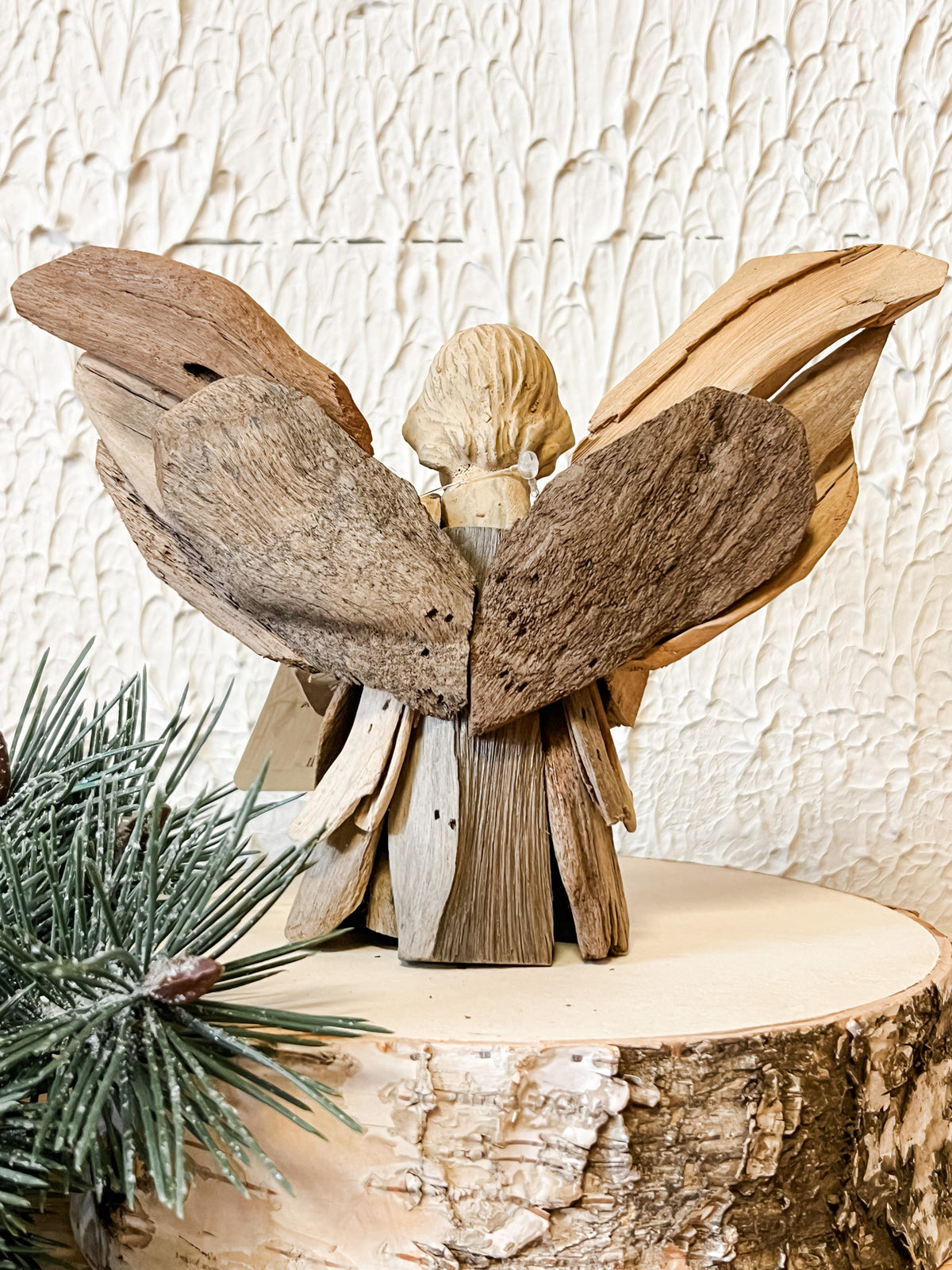 driftwood angel holding heart ornament at the rustic barn in killingworth ct