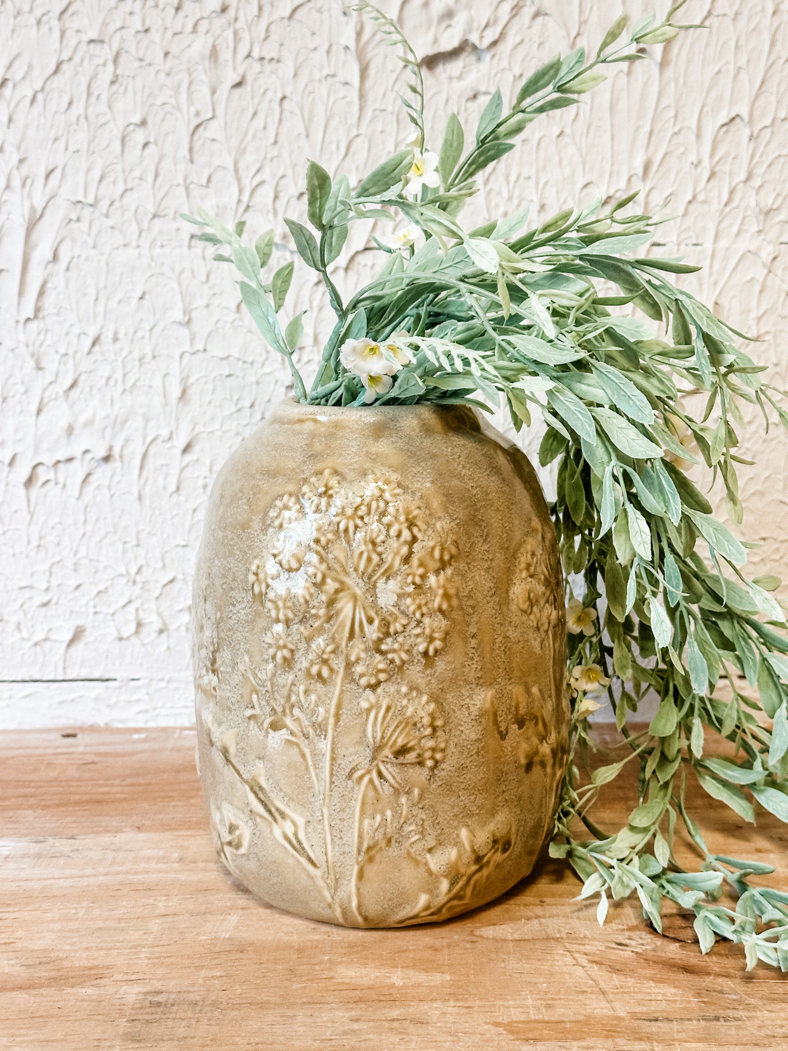 tan floral embossed ceramic vase at the rustic barn in killingworth ct