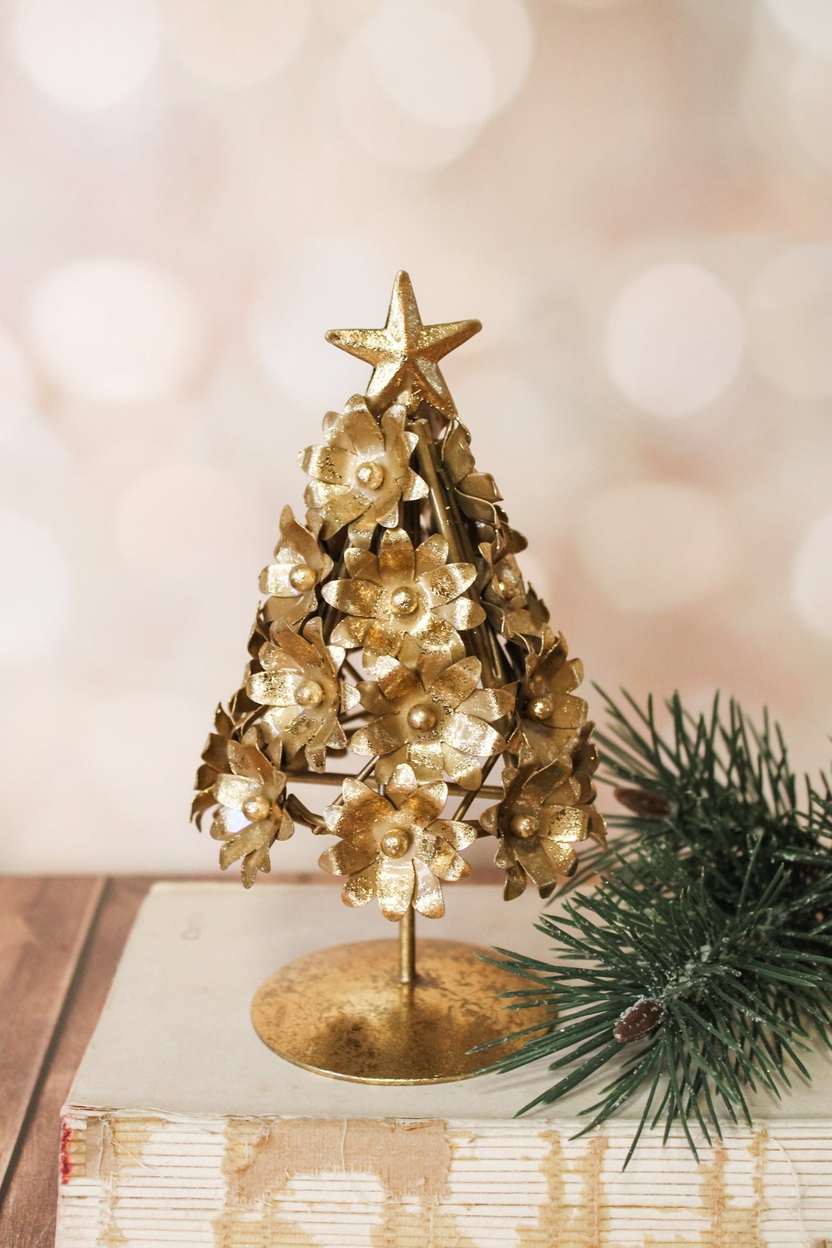 Elegant gold floral christmas metal tree sparkly with floral details and star for christmas for sale at the rustic barn. in killingworth, CT