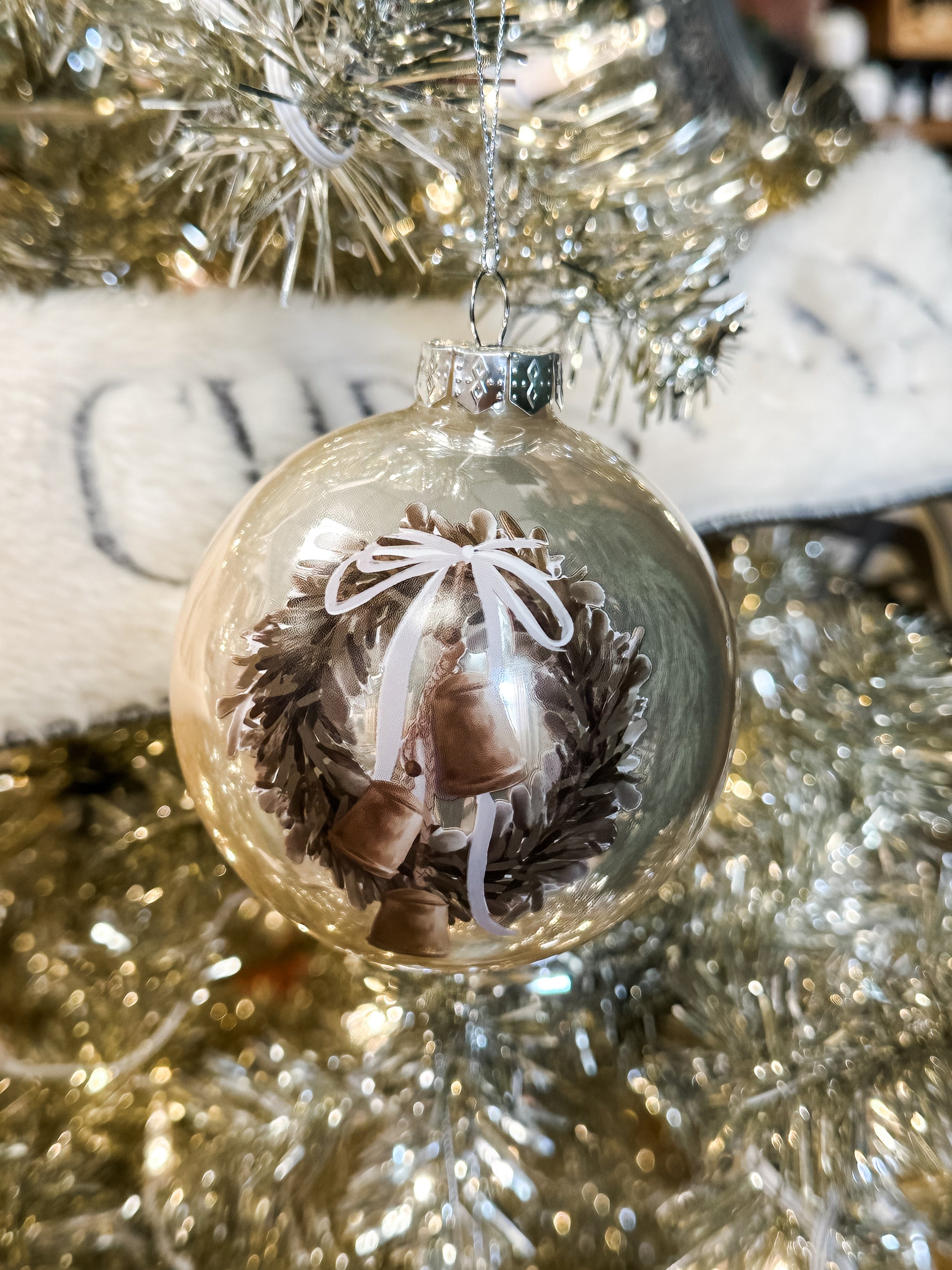 frosted round ornament with picture of wreath and bells at The Rustic Barn in Killingworth CT