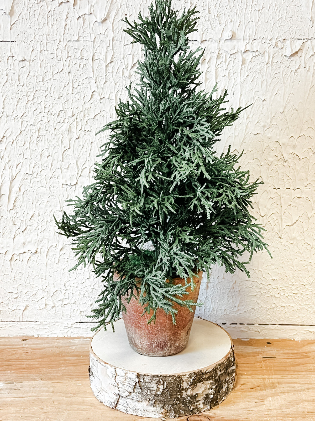 faux potted juniper christmas tree in cement pot at the rustic barn in killingworth ct