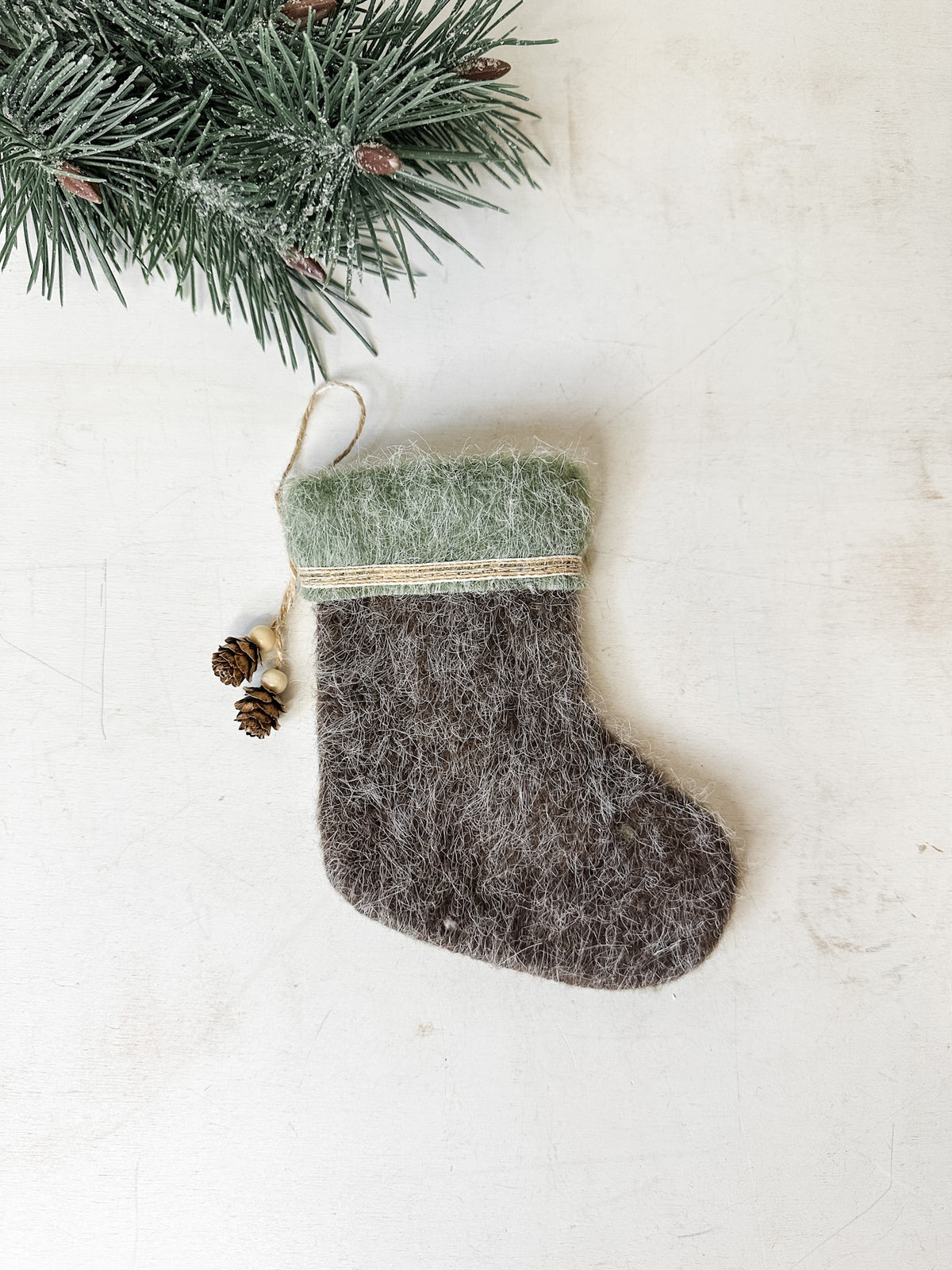 Felt stocking ornament green color with natural pinecone detailing for sale at the rustic barn in killingworth, CT