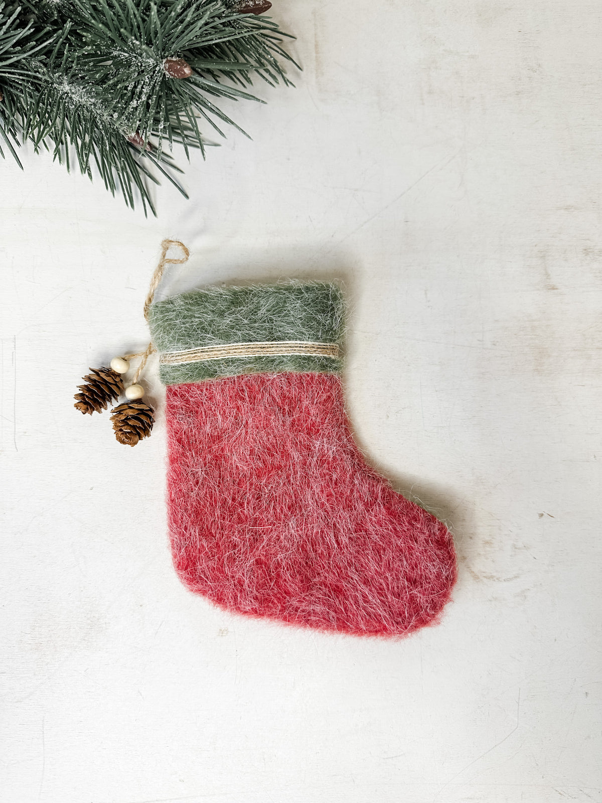 Felt stocking ornament red color with natural pinecone detailing for sale at the rustic barn in killingworth, CT