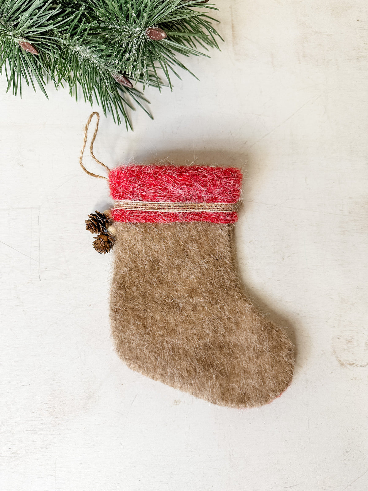 Felt stocking ornament white color wiith natural pinecone detailing for sale at the rustic barn in killingworth, CT