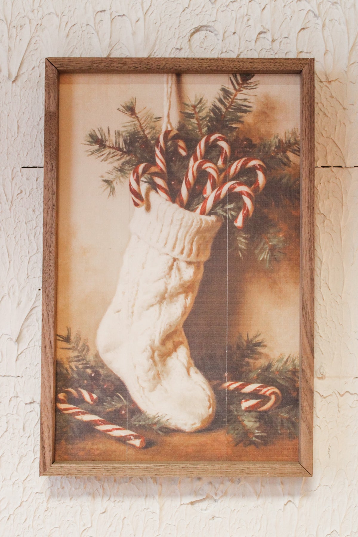 Festive Christmas candy cane holiday wall art for the home white stocking stuffed with candy canes and christmas greens for sale at the rustic barn in Killingworth, CT
