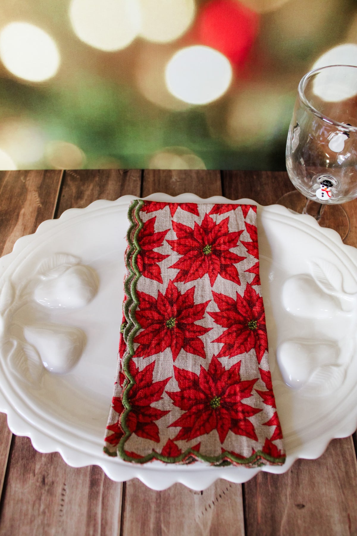 Festive green red and white holiday christmas napkins set of 4 with white berries, poinsettias, holly, red berries, and christmas prints with scalloped edge for sale at the rustic barn in killingworth, CT