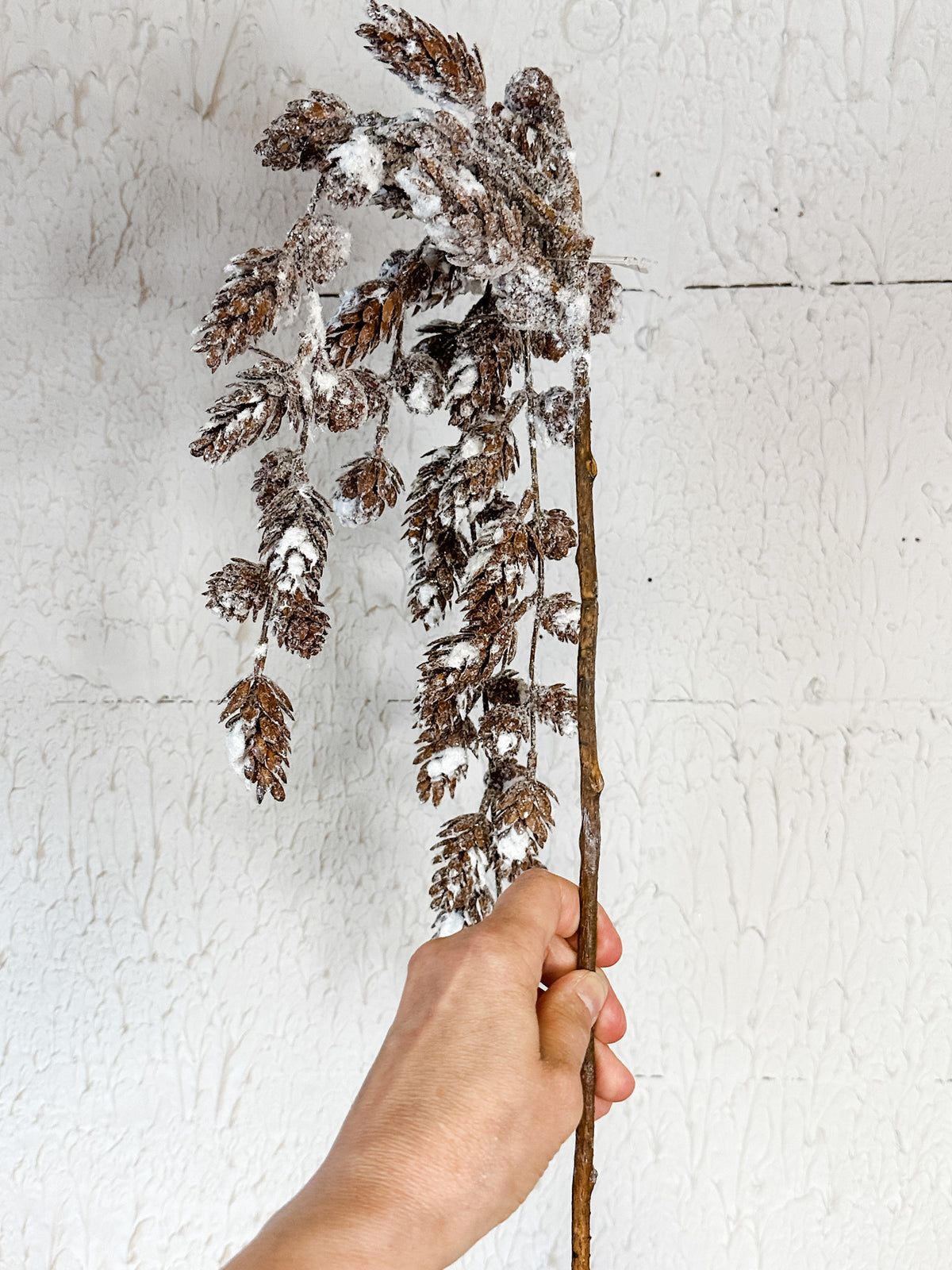 snow covered frosted pinecone spray at the rustic barn in killingworth ct