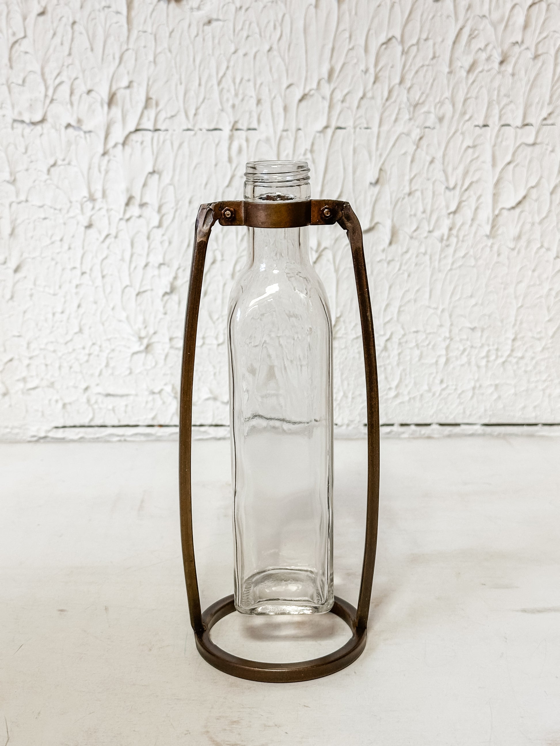 glass bottle vase in metal stand at The Rustic Barn in Killingworth, CT