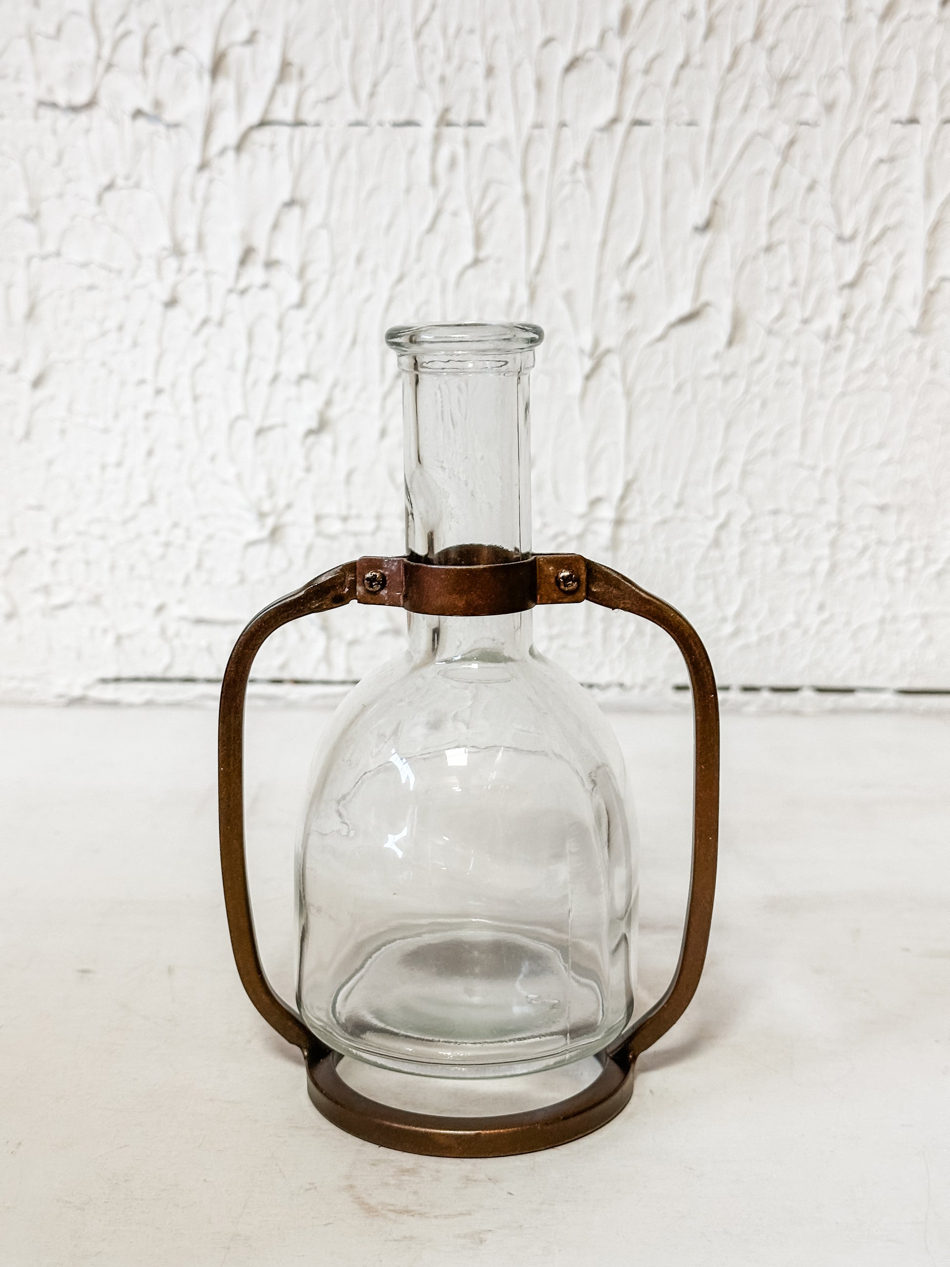 glass bottle vase in metal stand at The Rustic Barn in Killingworth, CT