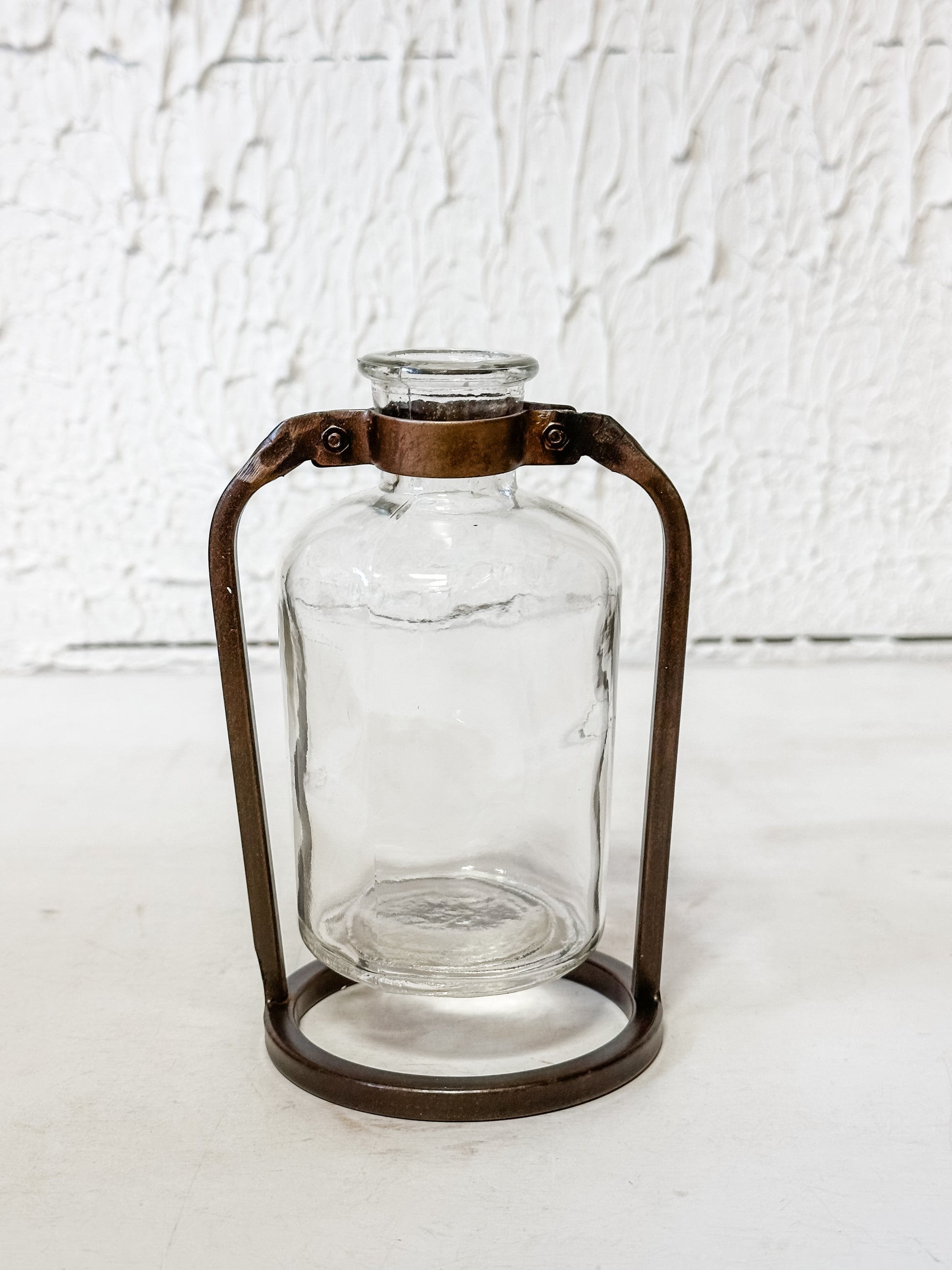 glass bottle vase in metal stand at The Rustic Barn in Killingworth, CT