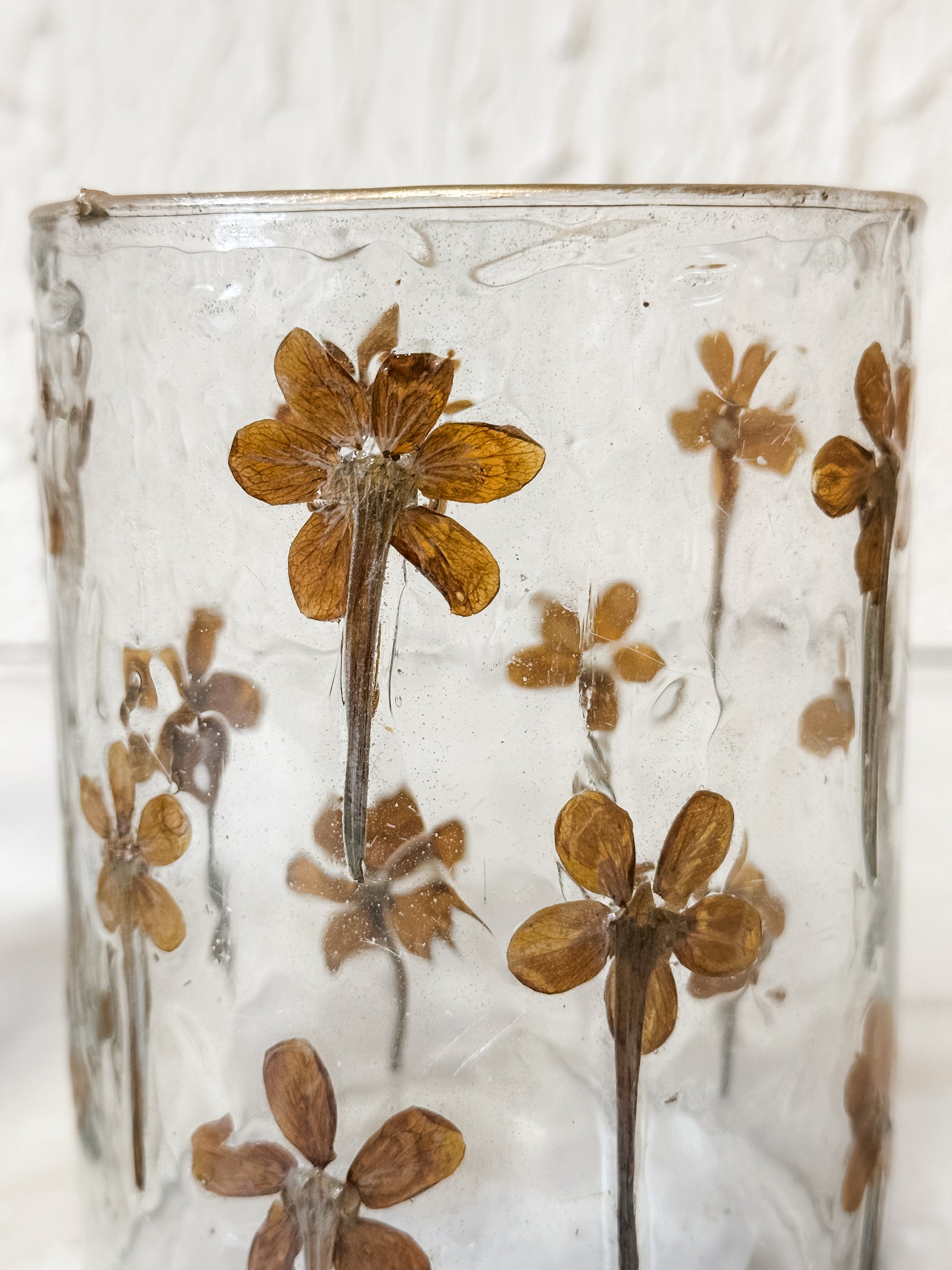 glass candle holder with pressed wildflower at The Rustic Barn in Killingworth, CT