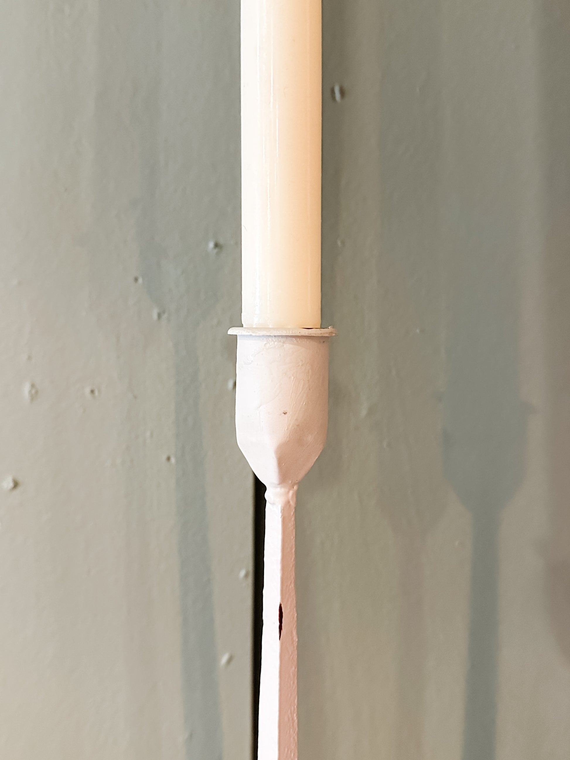 hand-forged metal taper holder with white finish at The Rustic Barn in Killingworth, CT