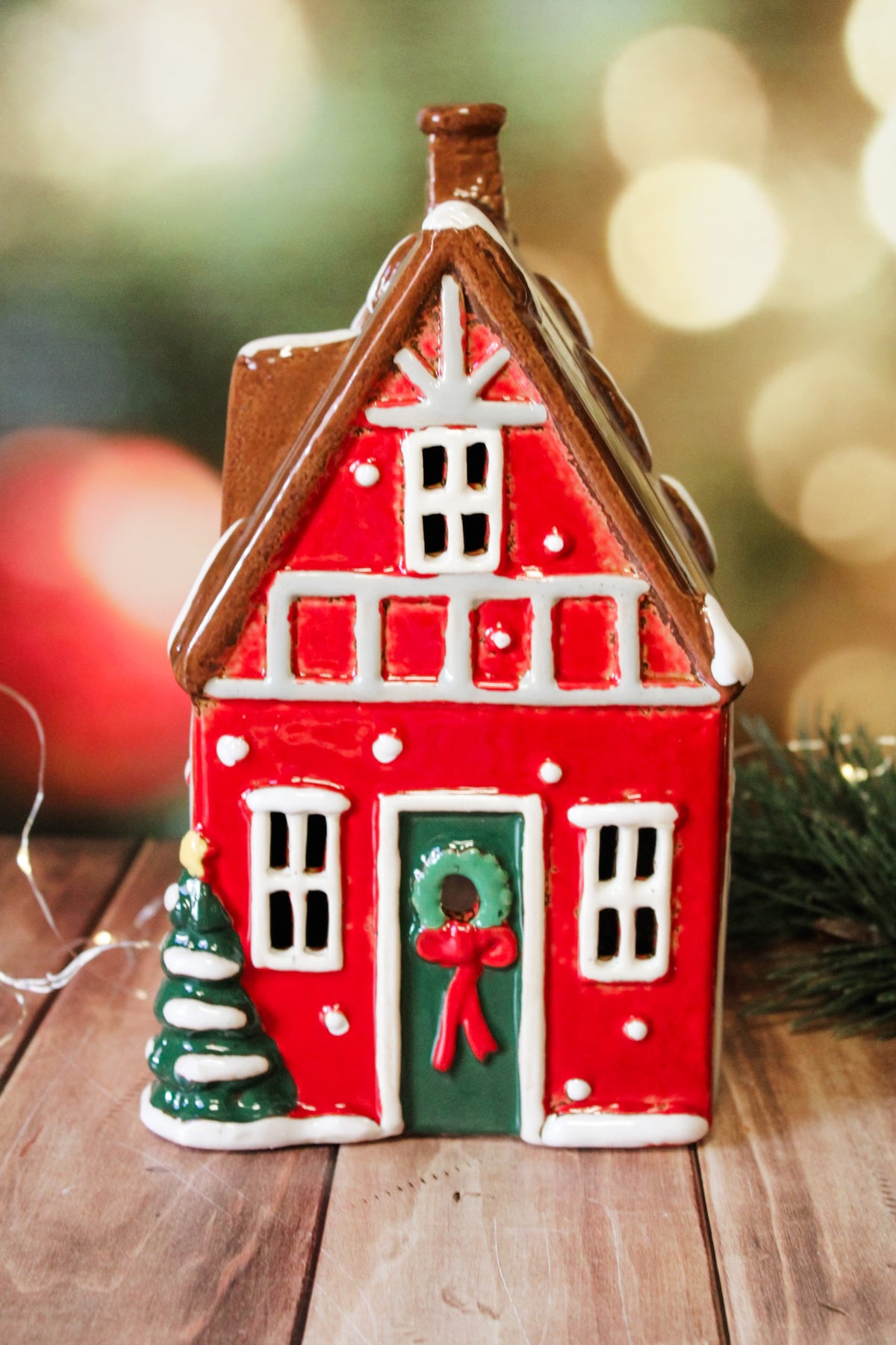 Hand painted holiday ceramic village houses with christmas trees, wreaths, bows, and lights with back open for candles and faux lights for sale at the rustic barn in Killingworth, CT