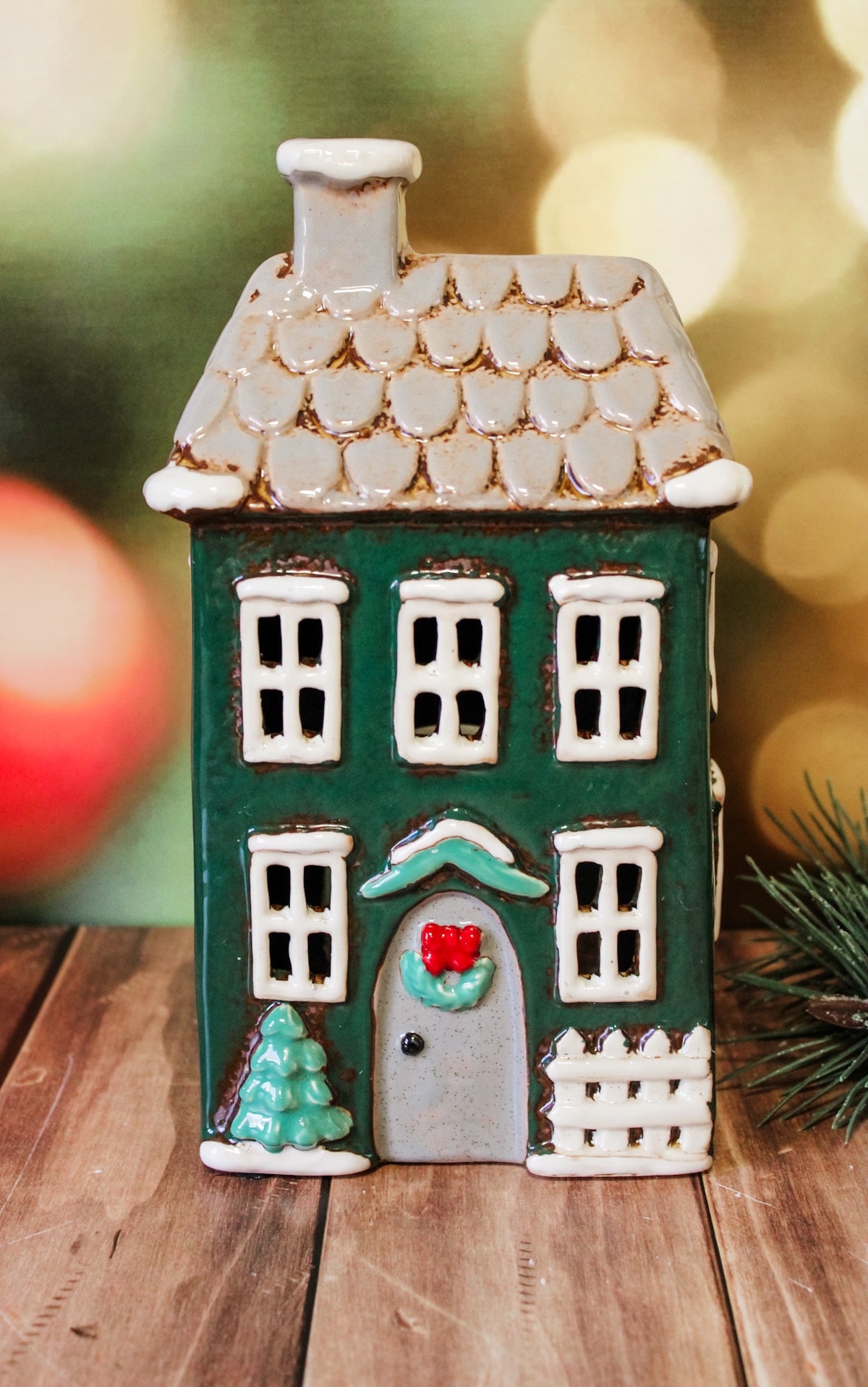 Hand painted holiday ceramic village houses with christmas trees, wreaths, bows, and lights with back open for candles and faux lights for sale at the rustic barn in Killingworth, CT